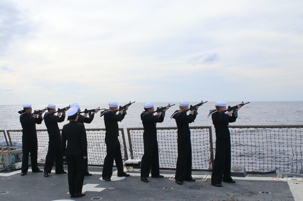 Gunner’s Mate Chief Petty Officer Stephanie Johnson leads a 21-Gun Salute in honor of those laid to rest during the Burial at Sea ceremony aboard USS Truxtun. (Photo by Ens Brady Reuter)