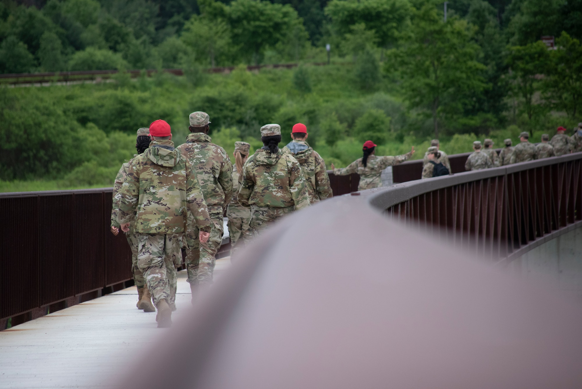 Pennsylvania Air National Guard members attending the 2021 Airman Development Program walk over a bridge at the Flight 93 Memorial in Stoystown, Pennsylvania, June 11, 2021.