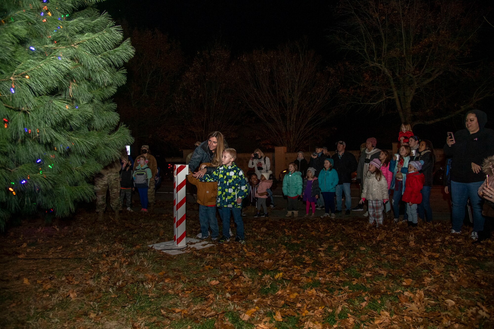 The Romeyn family helps light the Dover Air Force Base Holiday Tree during the annual Holiday Parade and Tree Lighting Ceremony at Dover AFB, Delaware, Dec. 1, 2021. The annual ceremony marks the start of the holiday season on base. (U.S. Air Force photo by Tech. Sgt. Nicole Leidholm)