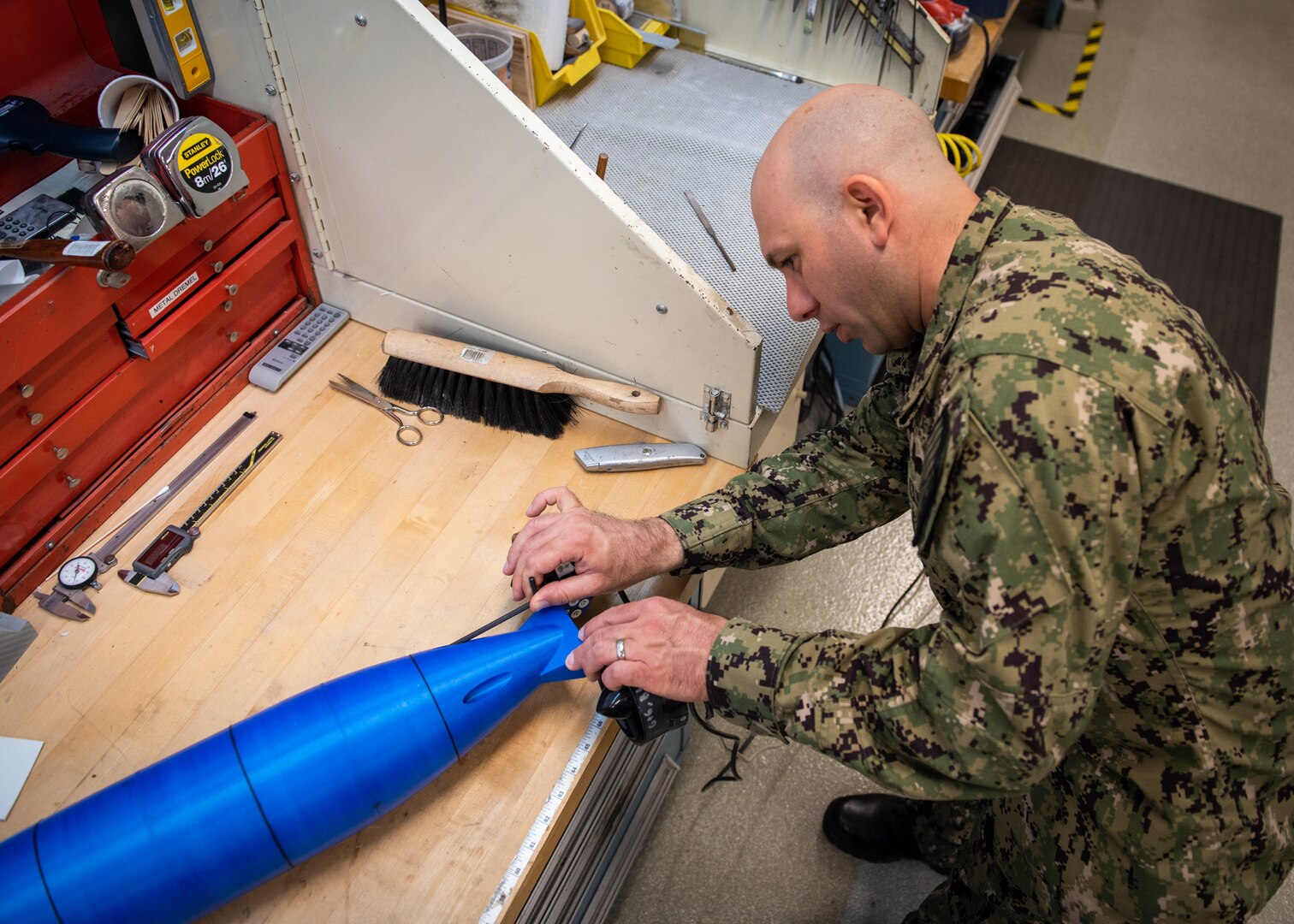 Lt. Brian Adornato, Engineering Duty Officer Reservist assigned to SurgeMain Atlanta, attaches the aft section of the unmanned underwater vehicle prototype to the hull. This process allows the whole craft to stay together as one piece and become watertight.