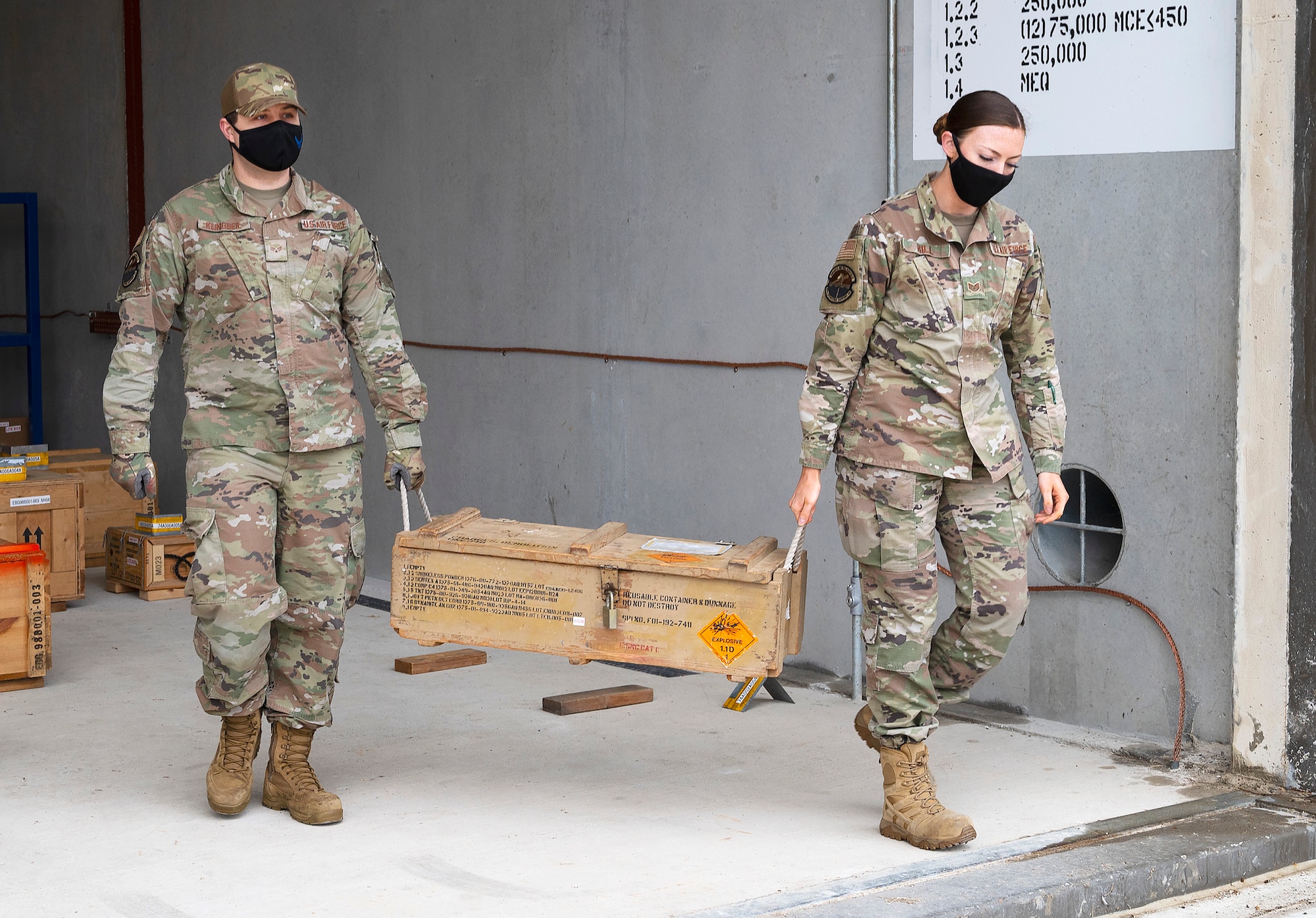 enior Airman Ryan Klingbeil and Staff Sgt. Jacklyn Hill, 88th Operations Support Squadron Munitions Flight inspectors, carry an explosives crate out of a storage igloo Nov. 17, 2021, at Wright-Patterson Air Force Base, Ohio. The 88th Security Forces Squadron’s K-9 unit used the explosives to train its military working dogs. (U.S. Air Force photo by R.J. Oriez)