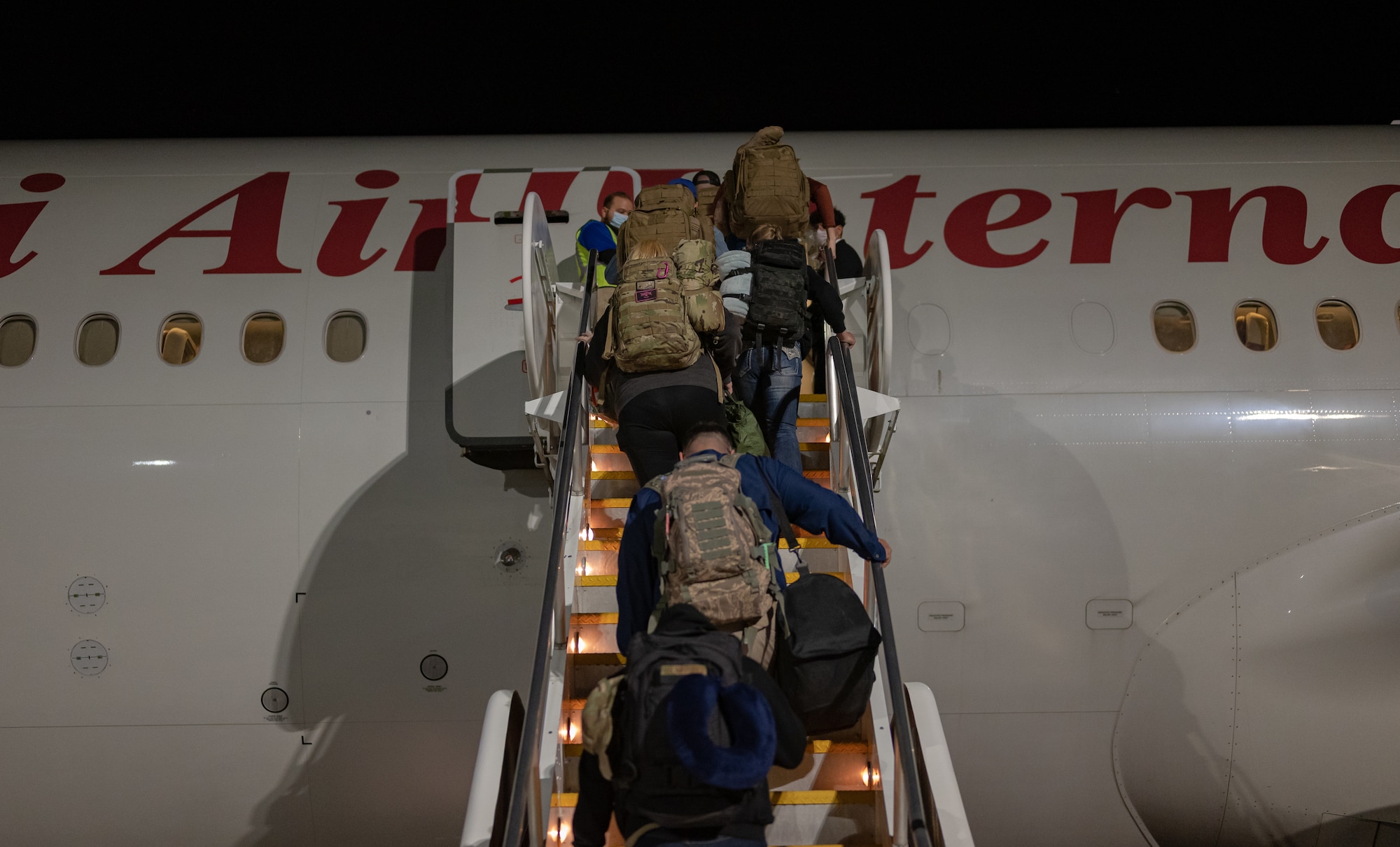 Airmen from the Nevada Air National Guard board an Omni Air International Boeing 777 prior to departing for a deployment at the Nevada Air National Guard Base, Reno, Nevada, Nov. 28, 2021.