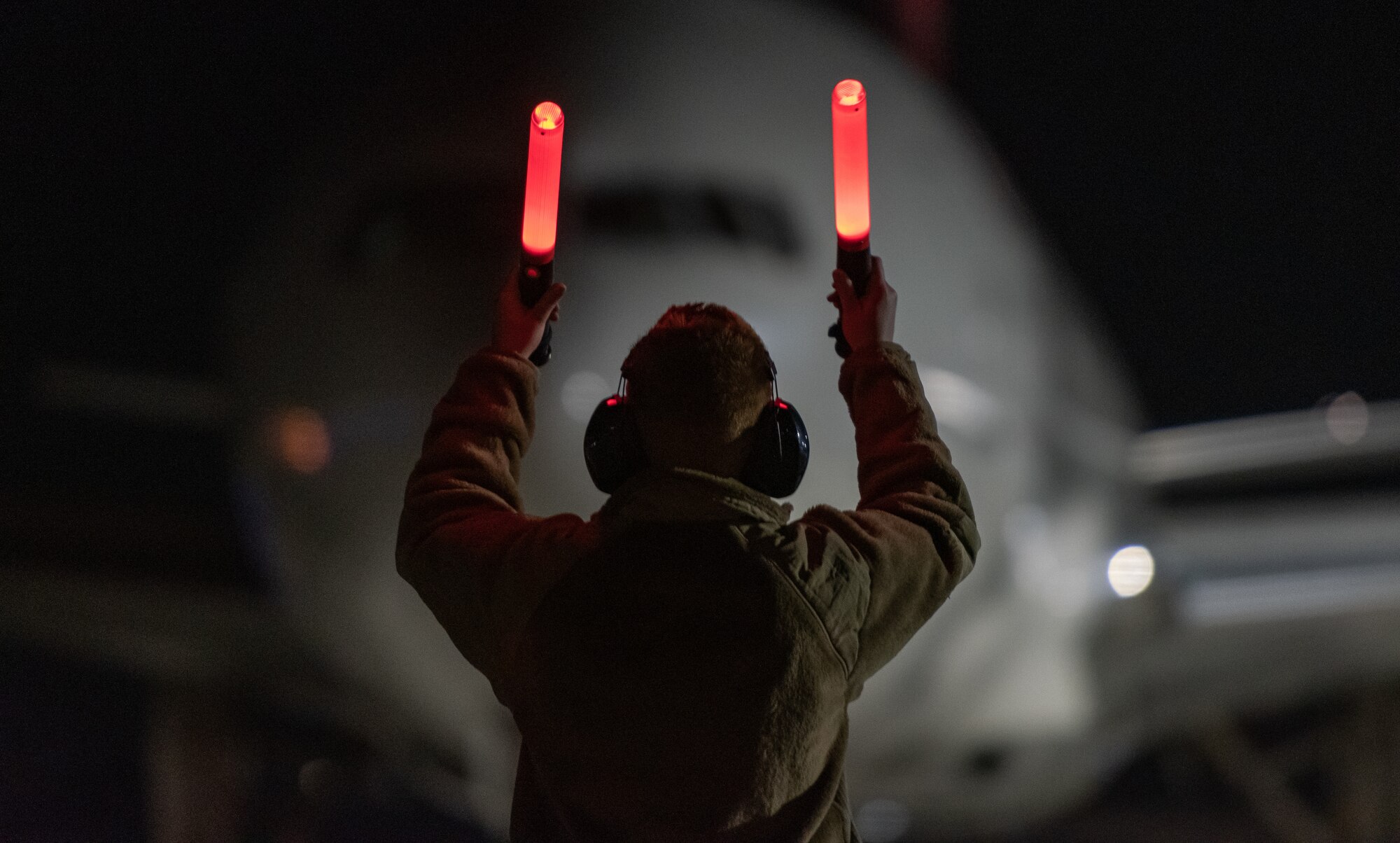 U.S. Air Force Senior Airman Alexia Ball, 152nd Aircraft Maintenance Squadron crew chief, marshals an Omni Air International Boeing 777 prior to departing at the Nevada Air National Guard Base, Nevada.