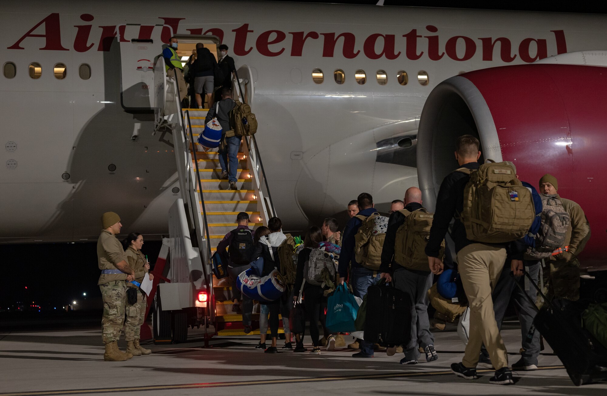 Airmen from the Nevada Air National Guard board an Omni Air International Boeing 777 prior to departing for a deployment at the Nevada Air National Guard Base, Reno, Nevada.