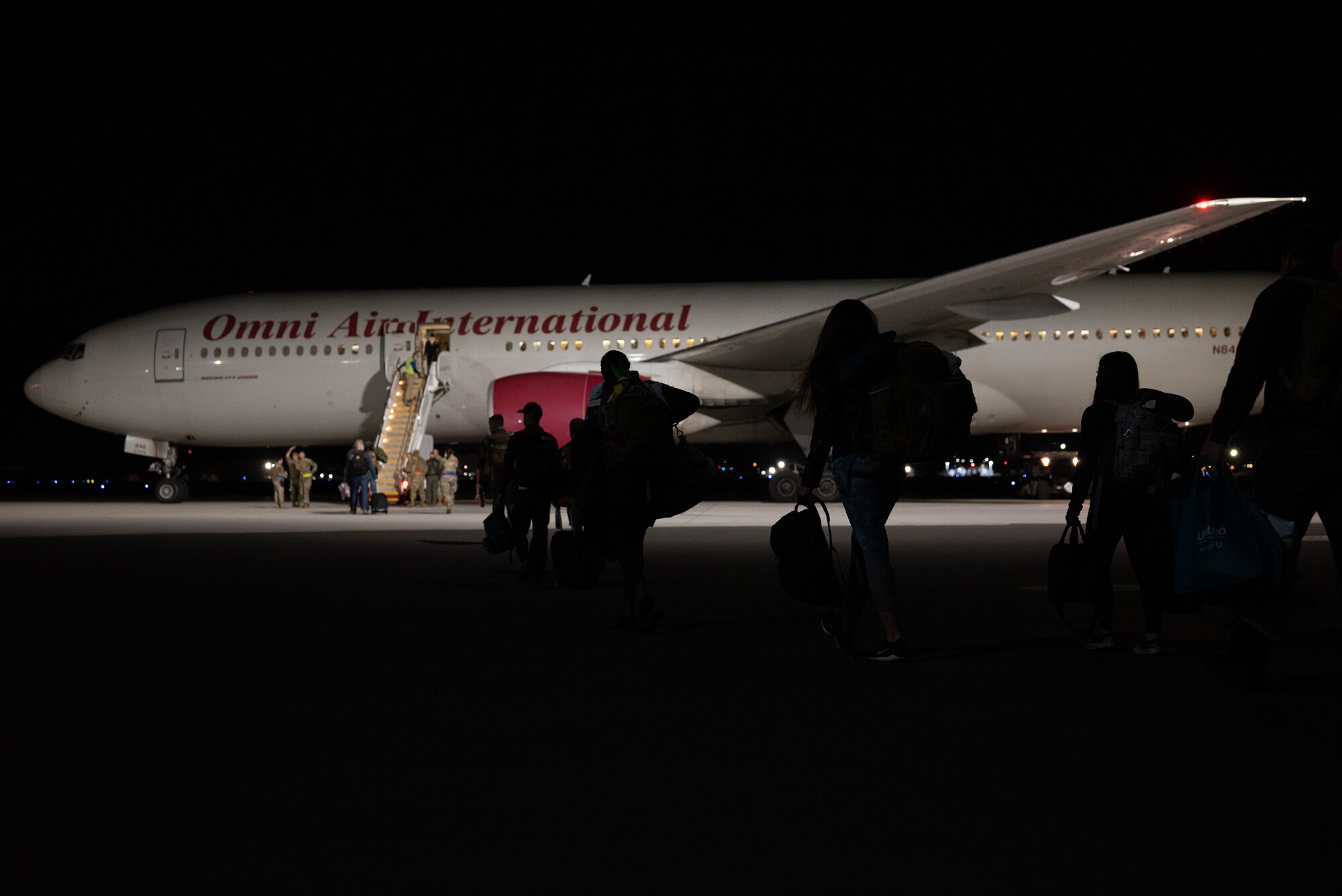 Airmen from the Nevada Air National Guard board an Omni Air International Boeing 777 prior to departing for a deployment at the Nevada Air National Guard Base, Reno, Nevada.