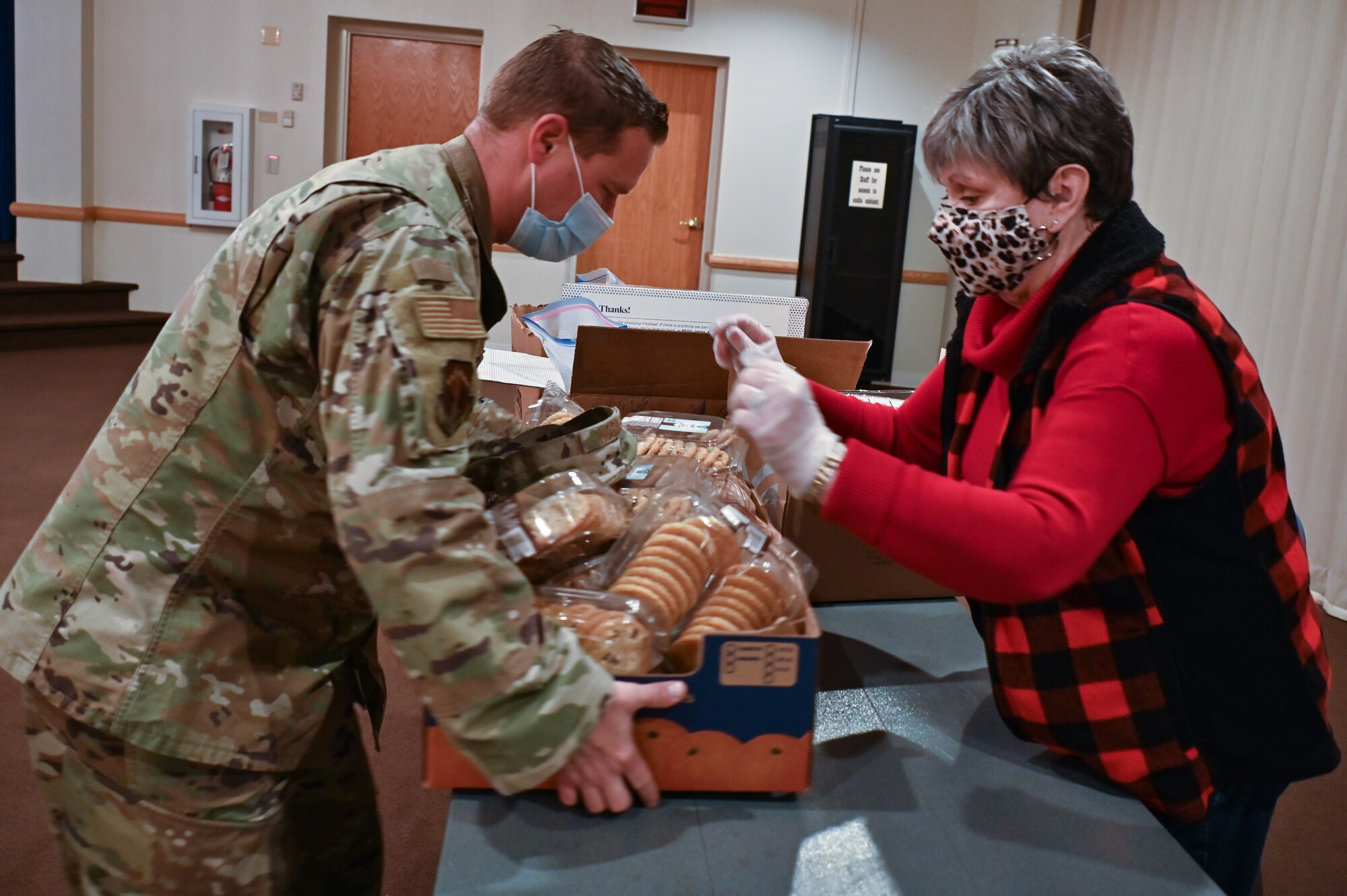 The Air Force Association Cowboy Chapter, Warren Spouses’ Club, Albertsons, base first sergeants, 90th Missile Wing Airman and Family Readiness Center and other community organizations joined together to deliver more than 500 dozen cookies to Airmen and families on F.E. Warren Air Force Base, Wyoming, Dec. 2, 2021. The Cheyenne community came together to spread some holiday cheer for Airmen and families of deployed members for the Air Force Association Cowboy Chapter’s Annual Cookie Drive. (U.S. Air Force photos by Joseph Coslett)