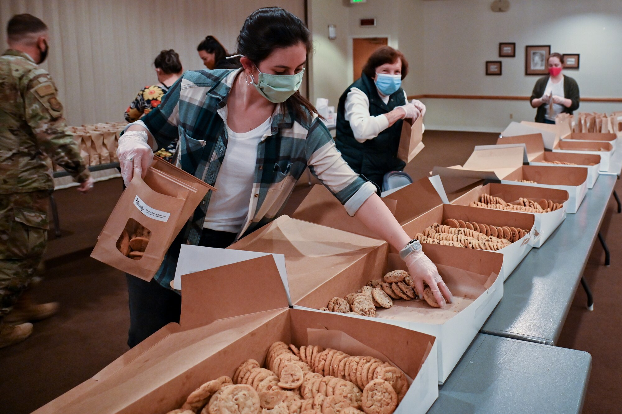 The Air Force Association Cowboy Chapter, Warren Spouses’ Club, Albertsons, base first sergeants, 90th Missile Wing Airman and Family Readiness Center and other community organizations joined together to deliver more than 500 dozen cookies to Airmen and families on F.E. Warren Air Force Base, Wyoming, Dec. 2, 2021. The Cheyenne community came together to spread some holiday cheer for Airmen and families of deployed members for the Air Force Association Cowboy Chapter’s Annual Cookie Drive. (U.S. Air Force photos by Joseph Coslett)