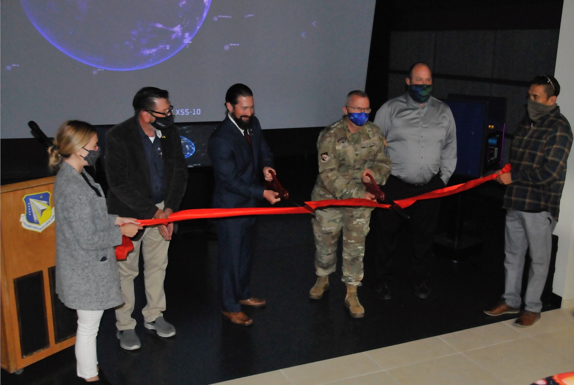 Col. Eric Felt, director of the Air Force Research Laboratory Space Vehicles Directorate and Dr. Darren Raspa, AFRL Phillips Research Site historian, cut the ribbon to open the directorate’s Legacy Portal Mission Control exhibit, at a ceremony held Nov. 15, 2021 at Kirtland AFB, N.M. Supporting them left to right: Gina Gutierrez, project manager; Bradley Rieck, senior facility engineer; Dan Von Tom, chief of the Corporate Information Office; and Victor Mace, project coordinator. (U.S. Air Force photo/Arturo Cardona)