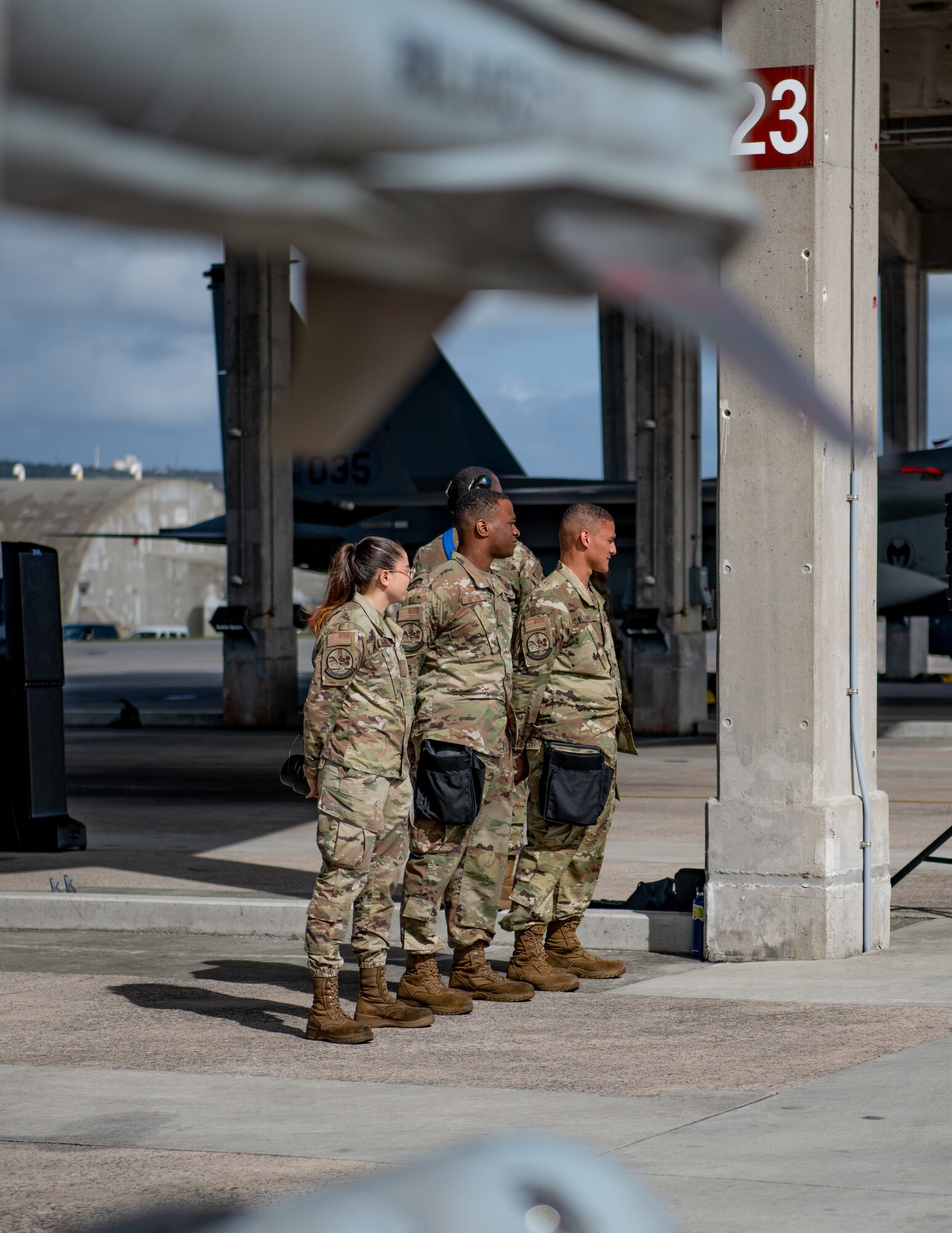 Three Airmen stand at parade rest