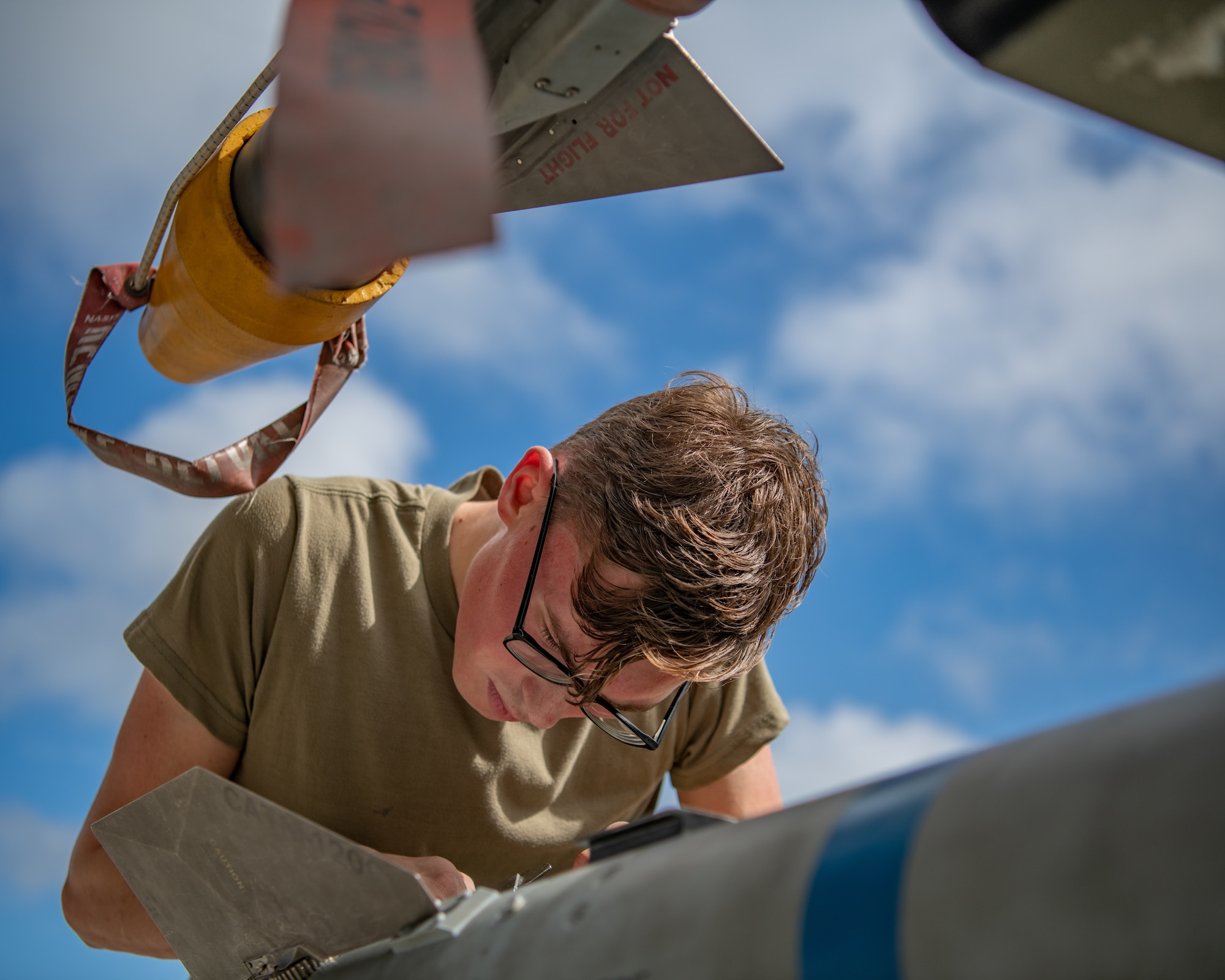 An Airman installs wings on a missile