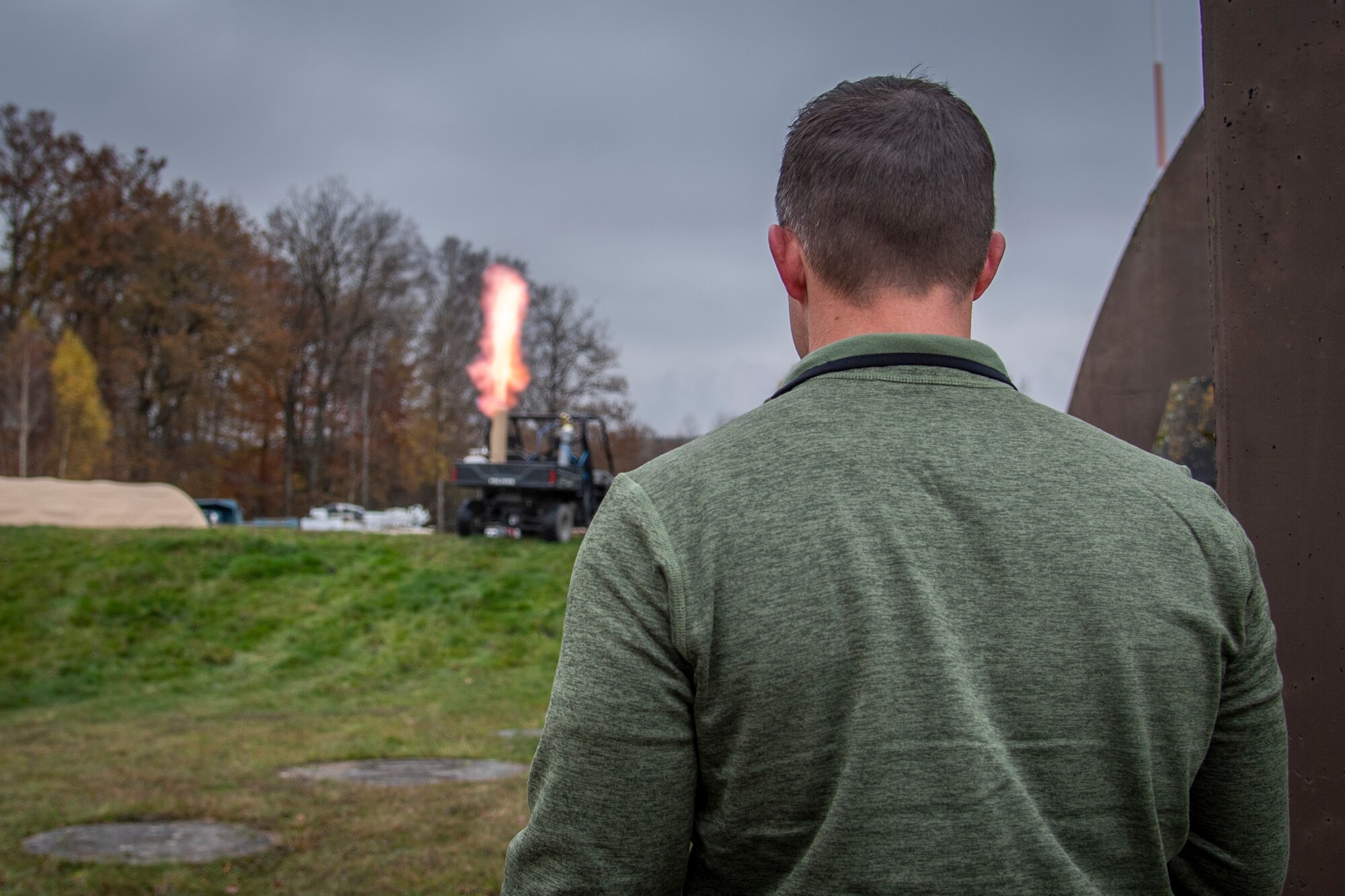U.S. Air Force Master Sgt. Nicholas Mosier, 435th Construction and Training Squadron cadre, uses a propane tank to simulate a base attack at Ramstein Air Base, Germany during a Silver Flag training course, Nov. 17, 2021.