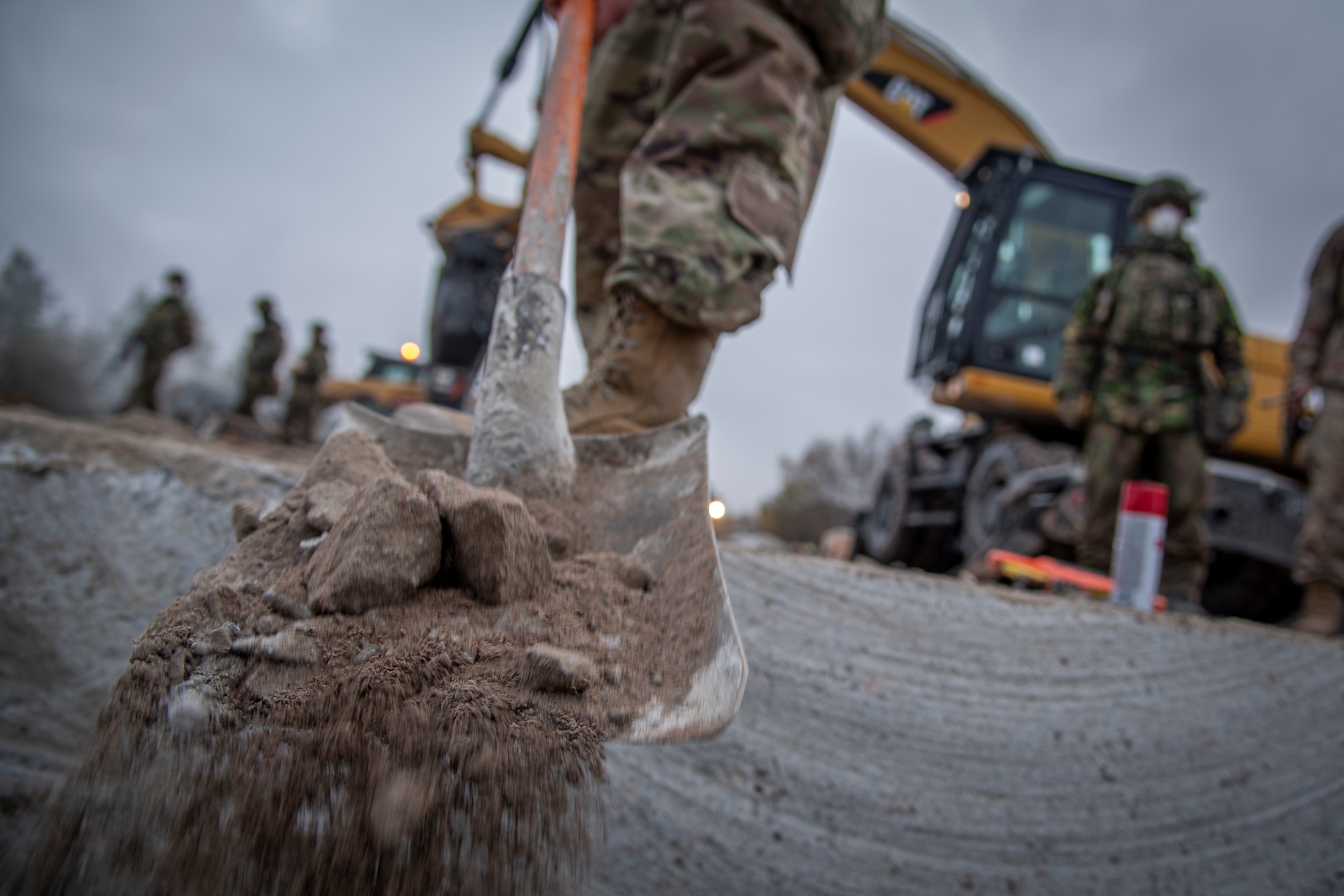 A U.S. Air Force Airman with the 435th Construction and Training Squadron clears debris during rapid airfield damage recovery training at Ramstein Air Base, Germany during a Silver Flag training course, Nov. 18, 2021.
