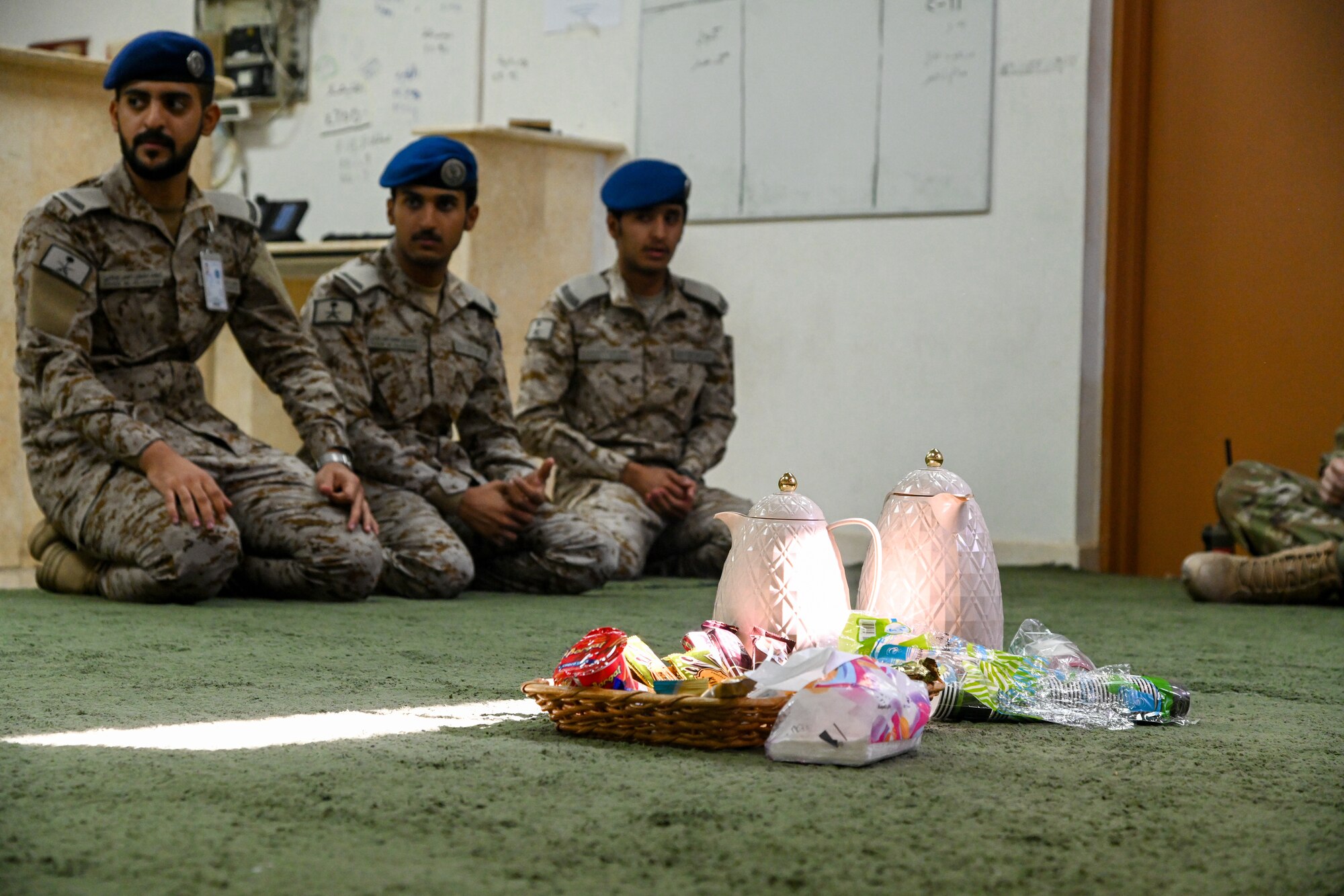 Service members from the Royal Saudi Air Force prepare tea for Airmen from the 378th Expeditionary Civil Engineer Squadron fire department during an integrated training at Prince Sultan Air Base, Kingdom of Saudi Arabia, Nov. 24, 2021. The training included a briefing from the RSAF fire chief on the operational structure of the RSAF fire department. (U.S. Air Force photo by Staff Sgt. Christina Graves)