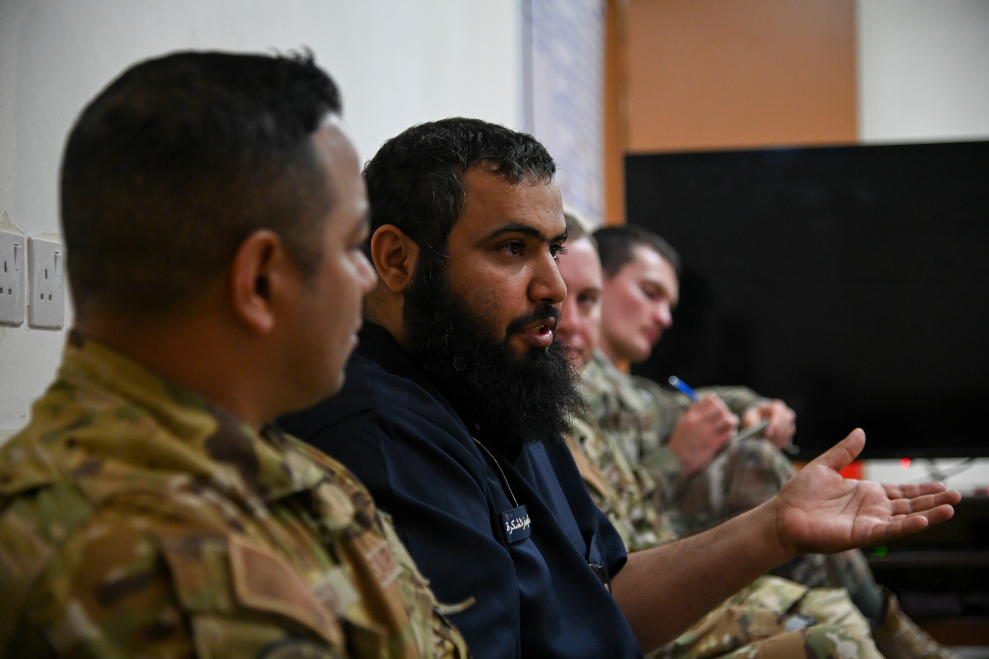 Chief Salem al Shakrh, Royal Saudi Air Force fire chief, speaks to members of the 378th Expeditionary Civil Engineer Squadron fire department during an integrated training at Prince Sultan Air Base, Kingdom of Saudi Arabia, Nov. 24, 2021. The training allowed service members the opportunity to strengthen their working relationship with their respective RSAF counterparts. (U.S. Air Force photo by Staff Sgt. Christina Graves)