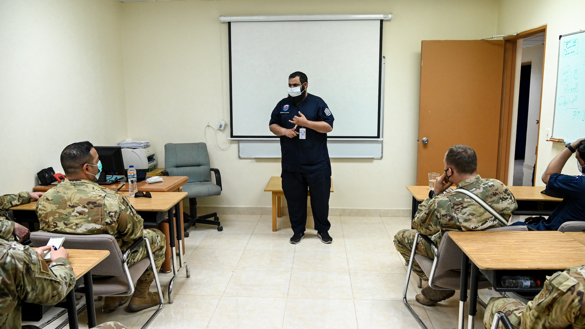 Chief Salem al Shakrh, Royal Saudi Air Force fire chief, briefs members of the 378th Expeditionary Civil Engineer Squadron fire department during an integrated training at Prince Sultan Air Base, Kingdom of Saudi Arabia, Nov. 24, 2021. The briefing explained the administrative structure and operational capabilities of the RSAF fire department. (U.S. Air Force photo by Staff Sgt. Christina Graves)