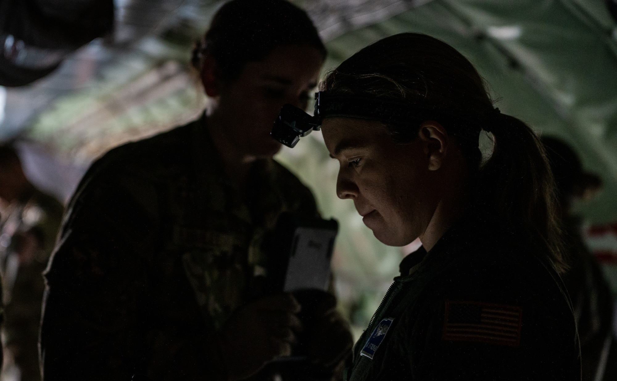 U.S. Air Force Capt. Samantha Stilwell, 86th Aeromedical Evacuation Squadron medical crew director, reviews a checklist during an aeromedical evacuation readiness exercise at Ramstein Air Base, Germany, Nov. 18, 2021. The mission allowed Airmen to train in a realistic environment to help build proficiency in their medical and operational skills. (U.S. Air Force photo by Senior Airman Jacob Wongwai)