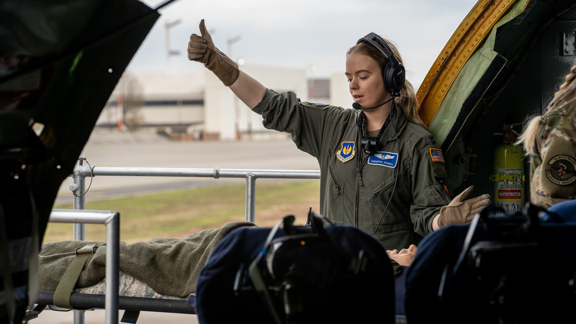 U.S. Air Force Capt. Samantha Stilwell, 86th Aeromedical Evacuation Squadron medical crew director, directs the onload of simulated patients during an aeromedical evacuation readiness exercise at Ramstein Air Base, Germany, Nov. 18, 2021. The 86 AES conducted the exercise in a realistic environment to hone Airmen’s medical and operational skills while also accomplishing mission qualifications and required semi-annual training events. (U.S. Air Force photo by Senior Airman Jacob Wongwai)
