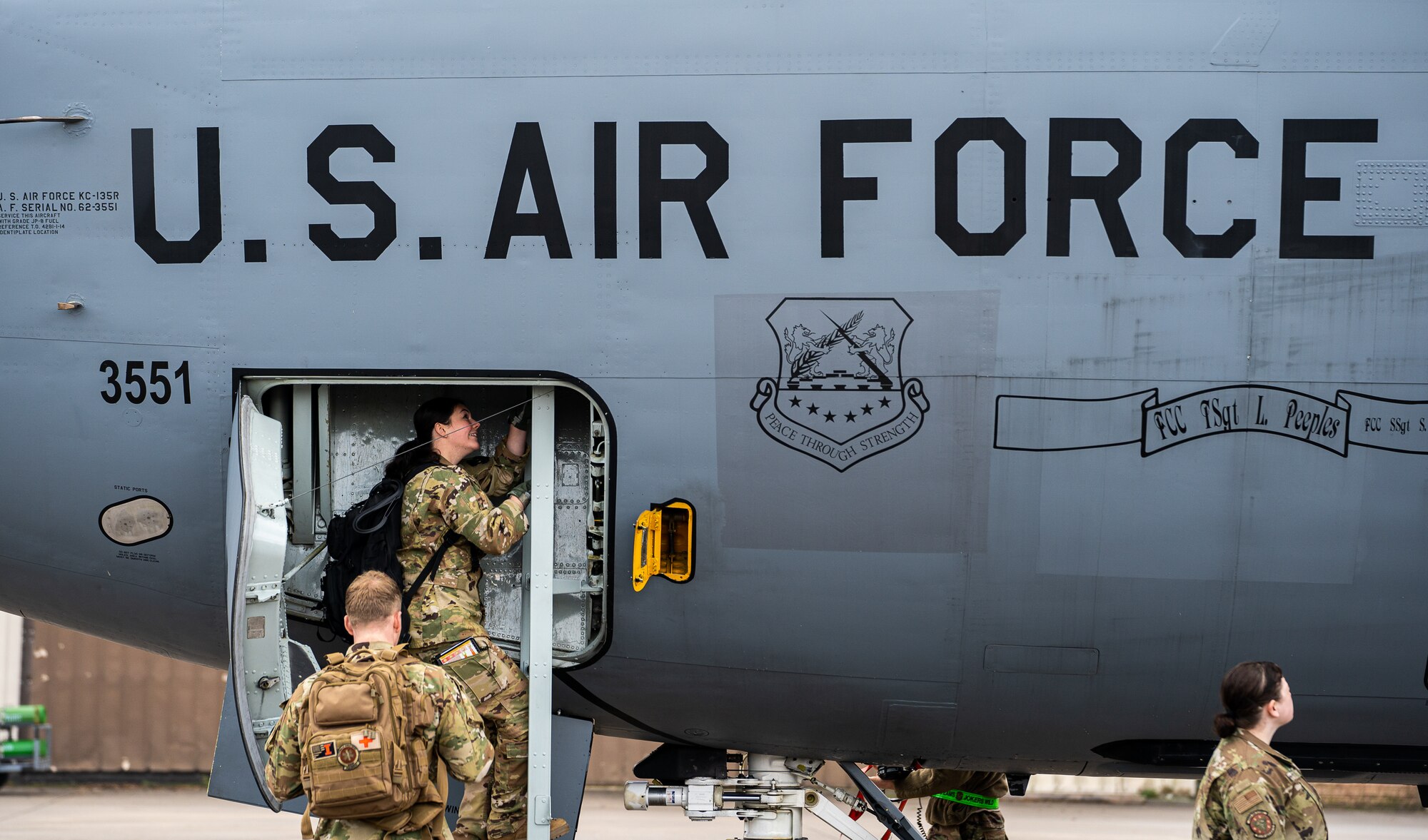 U.S. Air Force Airmen from the 86th Aeromedical Evacuation Squadron, climb through a KC-135 Stratotanker entrance chute during an aeromedical evacuation readiness exercise at Ramstein Air Base, Germany, Nov. 18, 2021. Airmen from 86 AES worked with the 100th Air Refueling Wing during the training as a way to exercise proficiency while building partnerships with other units. (U.S. Air Force photo by Senior Airman Jacob Wongwai)