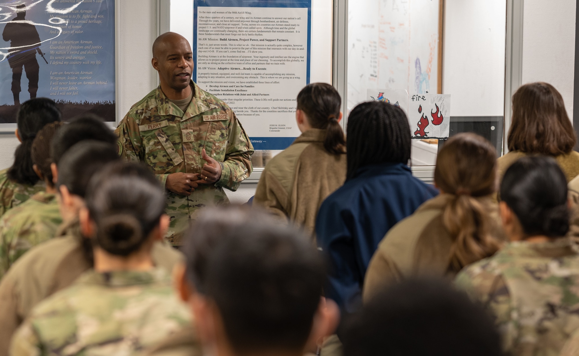 A military member speaking to a group of other military members.