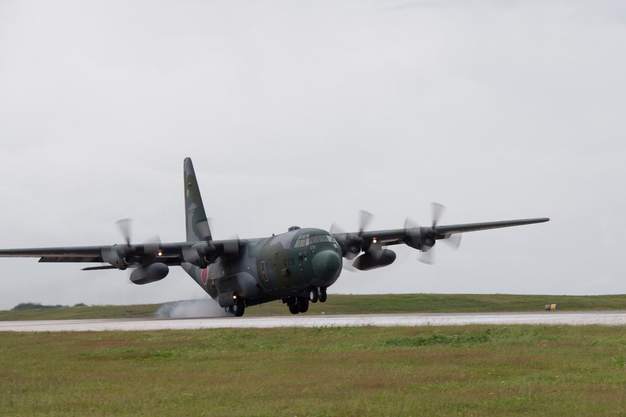 A Japan Air Self-Defense Force C-130H Super Hercules assigned to the 401st Squadron lands at Andersen Air Force Base, Guam, Dec. 1, 2021, for the 70th Anniversary of Operation Christmas Drop. The JASDF will provide food and supplies to 20,000 islanders in the Federated States of Micronesia and Republic of Palau as part of OCD to improve humanitarian assistance and disaster relief skills alongside the U.S. to enhance joint capabilities in case of real-world emergencies. (U.S. Air Force photo by Tech. Sgt. Joshua Edwards)
