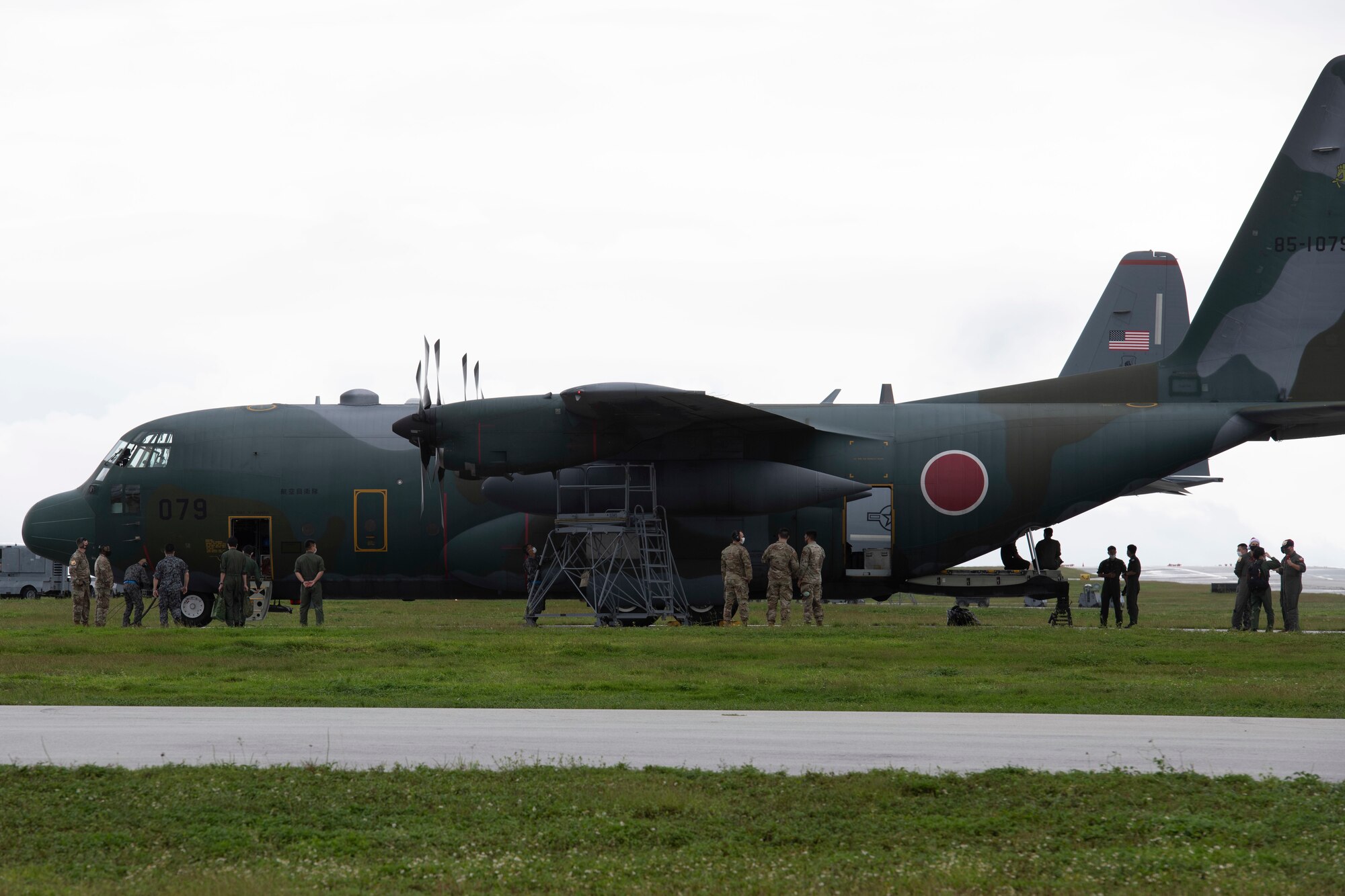 Members of the 374th Airlift Wing from Yokota Air Base, Japan, and Japan Air Self-Defense Force 401st Squadron meet after landing at Andersen Air Force Base, Guam, Dec. 1, 2021. Both the 374th AW and 401st SQ will provide support to more 20,000 islanders in the Federated States of Micronesia and Republic of Palau, during Operation Christmas Drop. This event creates opportunity for the U.S. to train alongside its allies and partners in the Pacific to refine joint skillsets necessary to react quickly and efficiently during a humanitarian assistance and disaster relieve event. (U.S. Air Force photo by Tech. Sgt. Joshua Edwards)
