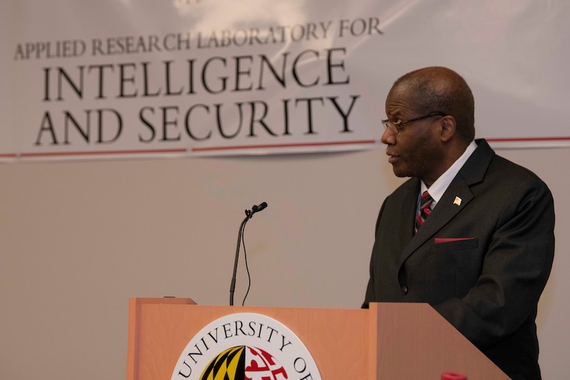 A man speaks from behind a lectern.