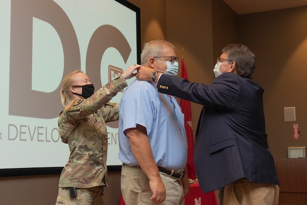 Terry Stanton (center) receives the Bronze Order of the de Fleury Medal for his hard work and service to the Army from Col. Teresa Schlosser (left), commander, U.S. Army Engineer Research and Development Center, and Bartley P. Durst (right), director, ERDC Geotechnical and Structures Laboratory. (U.S. Army Corps of Engineers photo)