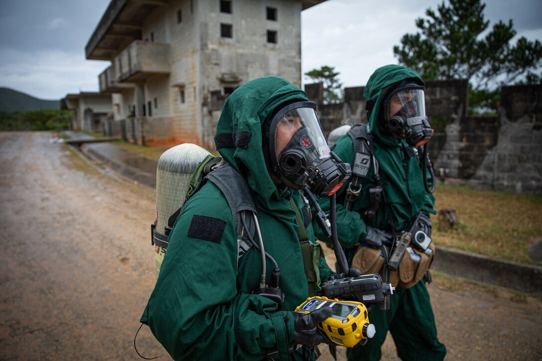 U.S. Marine Corps Cpl. Duy Nguyen, and Cpl. Kasey Dimatteo, with the 31st Marine Expeditionary Unit (MEU), wait to get cleared during a training exercise in Combat Town, Okinawa, Japan Nov. 29, 2021. The training exercise consisted of Marines responding accordingly to different CBRN attacks. The 31st MEU, the Marine Corps’ only continuously forward-deployed MEU, provides a flexible and lethal force ready to perform a wide range of military operations as the premiere crisis response force in the Indo-Pacific region. (U.S. Marine Corps photo by Lance Cpl. Malik Lewis)