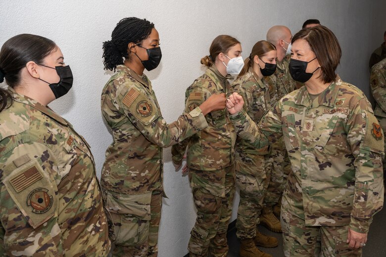 Military members greeting each other with a fist-bump.