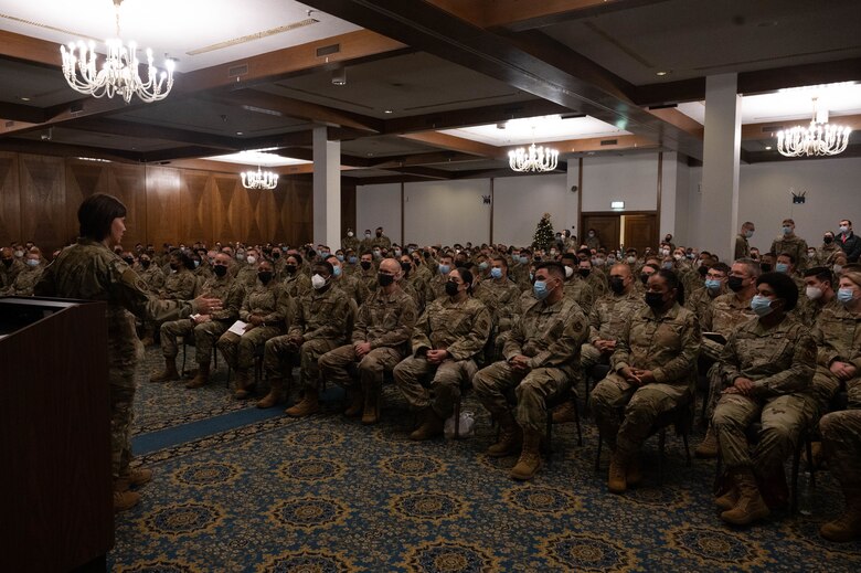 A military member speaking in front of a crowd.