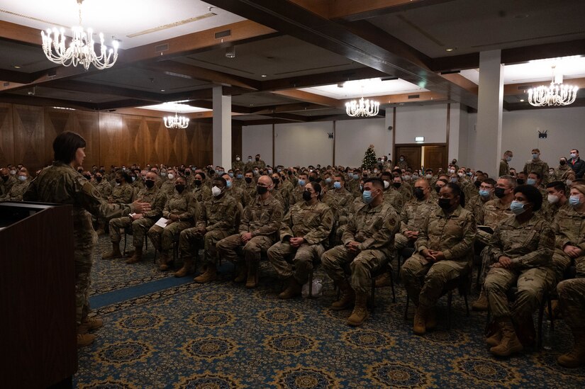 A military member speaking in front of a crowd.