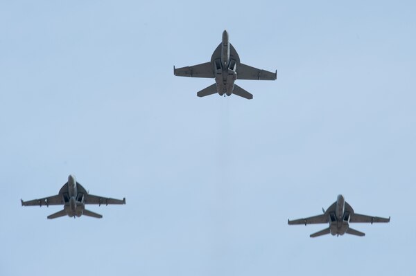 Cmdr. Erin E. Flint, prospective commanding officer of Strike Fighter Squadron (VFA) 131, and Cmdr. Samuel P. Morrison, commanding officer of VFA 131, conduct an aerial change of command