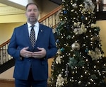 Man standing in front of decorated holiday tree