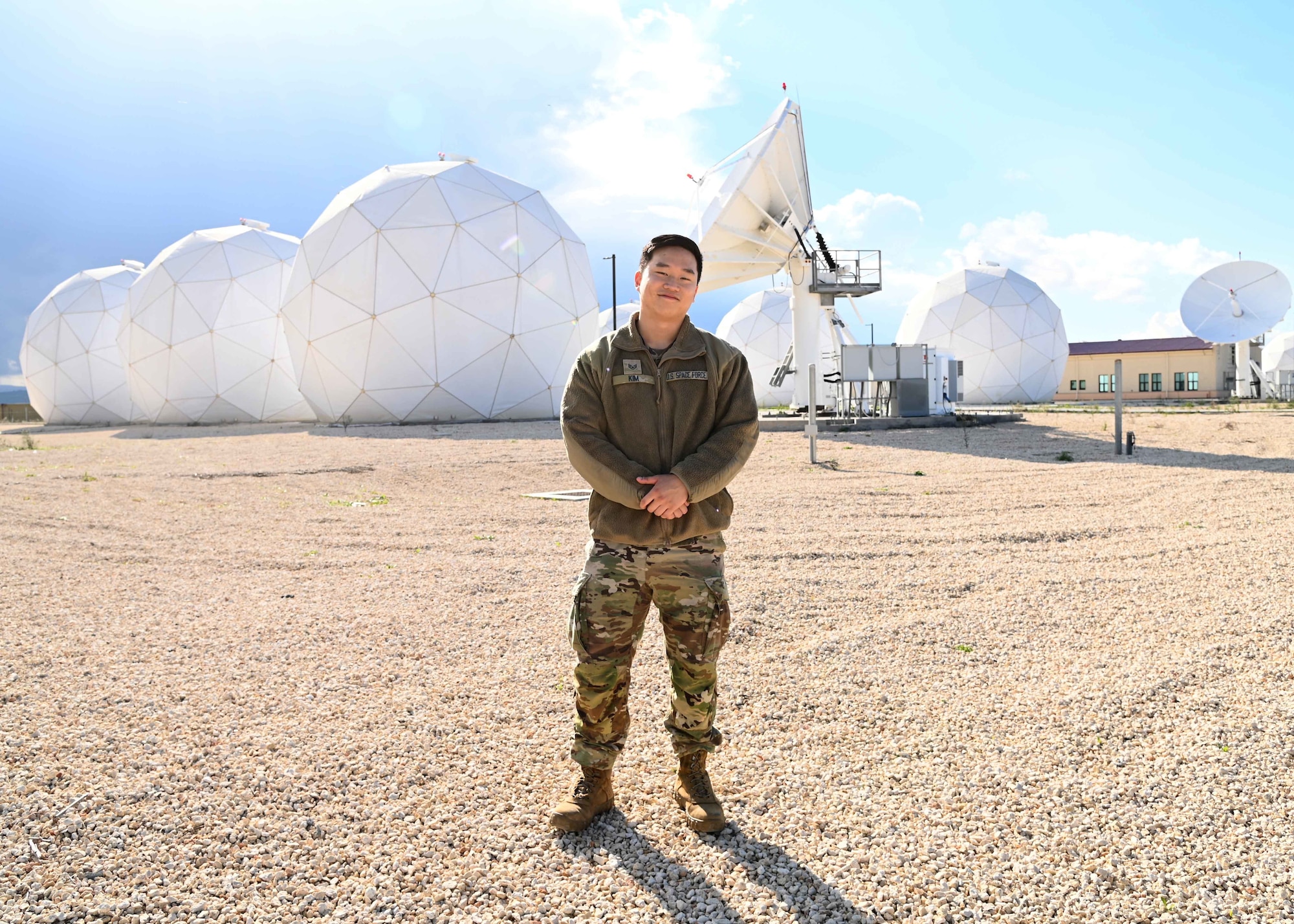 U.S. Space Force Sgt. David Kim, assigned to the 7th Reconnaissance Squadron, stands in front of his work site, Europe 3, a satellite communications facility at Naval Air Station Sigonella, Nov. 23, 2021. NAS Sigonella’s strategic location enables U.S., allied, and partner nation forces to deploy and respond as required, ensuring security and stability in Europe, Africa and Central Command.