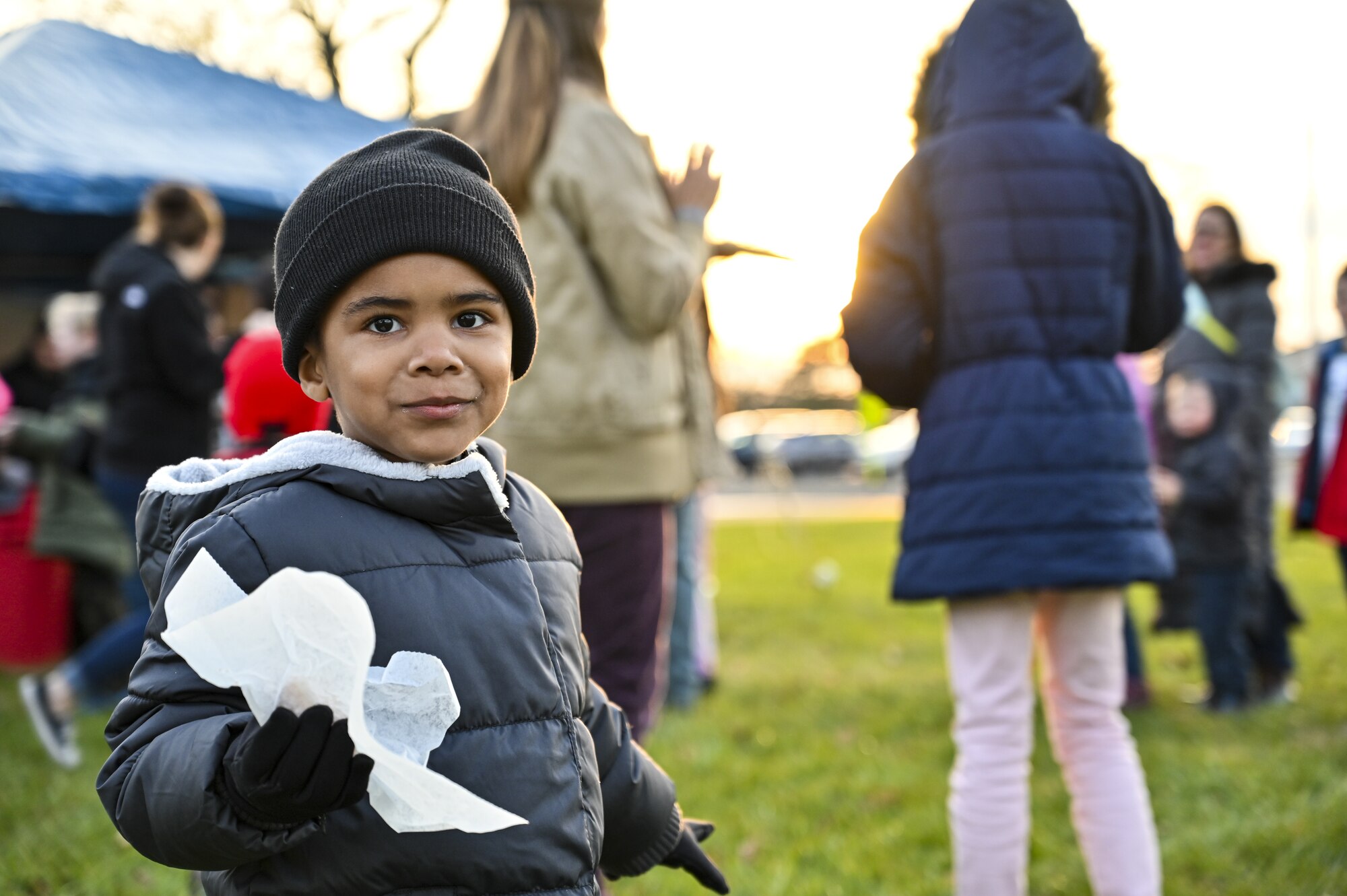 A child and dependent of a U.S. Army Non-Commission Officer poses for a photo during the Christmas Tree Lighting Ceremony held at Wurman Hall on Army Support Activity Dix, N.J., Dec 1, 2021. The annual tradition attended by leadership and Joint Base McGuire-Dix-Lakehurst families offered horse-drawn carriage rides, hot chocolate, cookies, funnel cake, pretzels, kettle corn and a special visit from the North Pole. (U.S. Air Force photo by SrA Matt Porter)