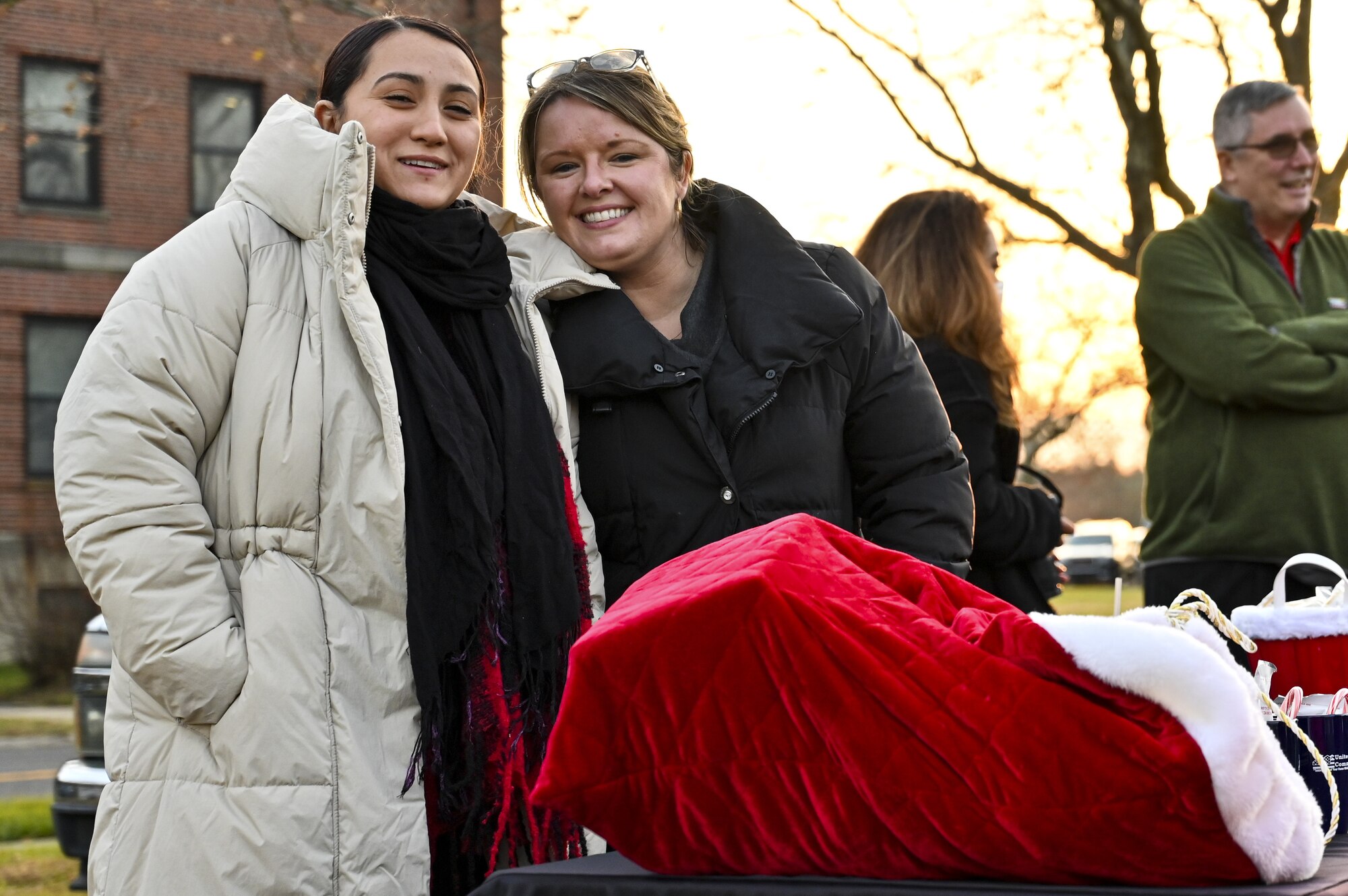 Members of the 87th Force Support Squadron pose for a photo during the Christmas Tree Lighting Ceremony held at Wurman Hall on Army Support Activity Dix, N.J., Dec 1, 2021. The annual tradition attended by leadership and JB MDL families offered horse-drawn carriage rides, hot chocolate, cookies, funnel cake, pretzels, kettle corn and a special visit from the North Pole. (U.S. Air Force photo by SrA Matt Porter)