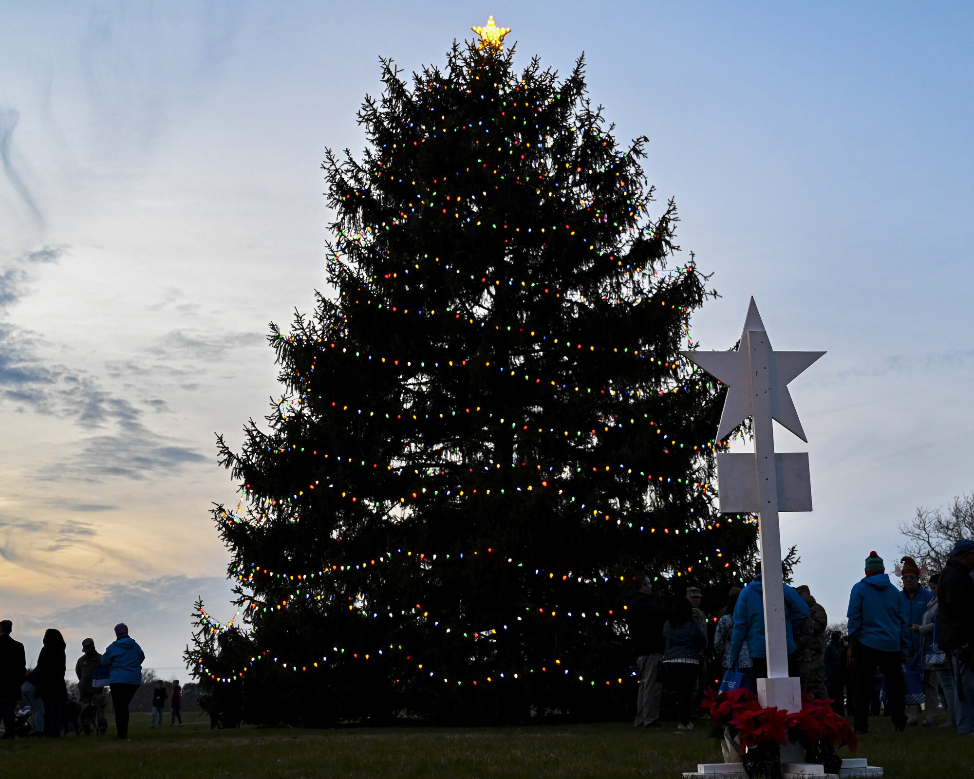 A large pine tree illuminates during the Christmas Tree Lighting Ceremony held at Wurman Hall on Army Support Activity Dix, N.J., Dec 1, 2021. The annual tradition attended by leadership and JB MDL families offered horse-drawn carriage rides, hot chocolate, cookies, funnel cake, pretzels, kettle corn and a special visit from the North Pole. (U.S. Air Force photo by SrA Matt Porter)