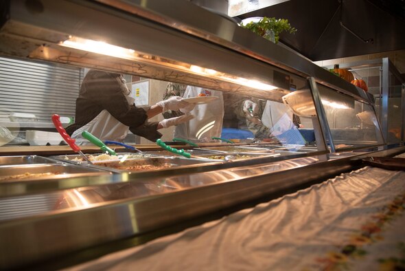 During the annual Thanksgiving celebration, U.S. Space Force Col. Shay Warakomski, Peterson-Schriever Garrison commander and his spouse Heather serve meals to Guardians, Airmen and civilians at the Aragon Dining Facility at Peterson Space Force Base, Colorado, Nov. 25, 2021.