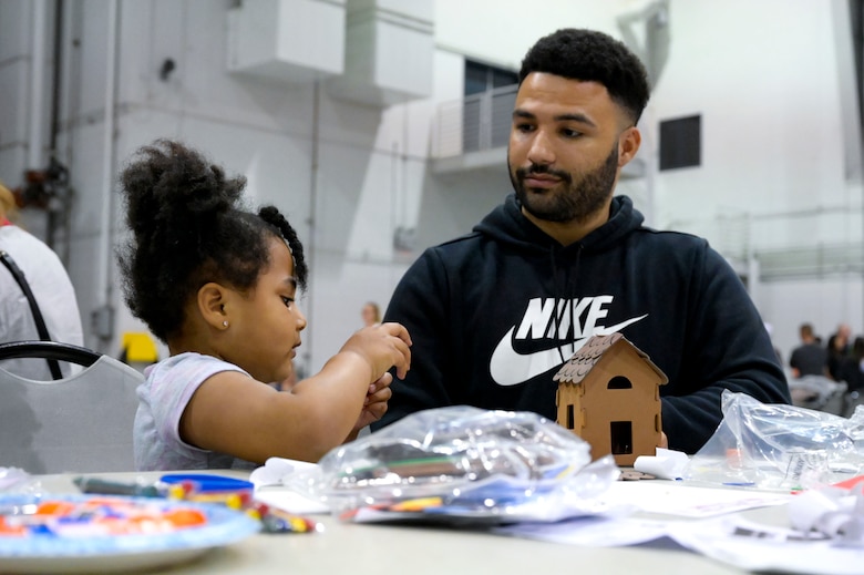A father and daughter participate in arts and crafts