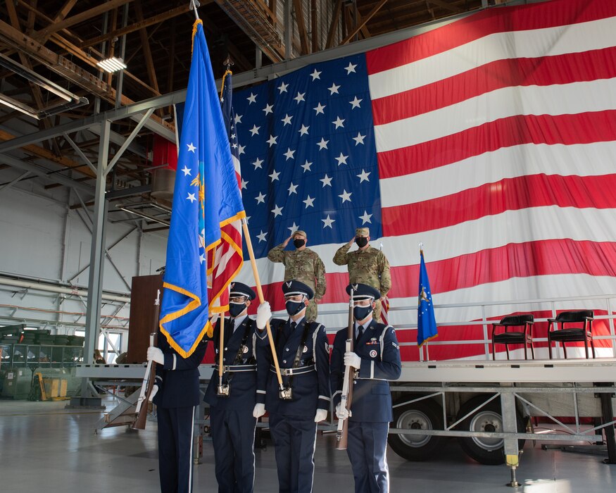 Col. DiVittorio and Maj. Griffin hold a salute behind the U.S. Air Force Color Guard during the playing of the United States National Anthem