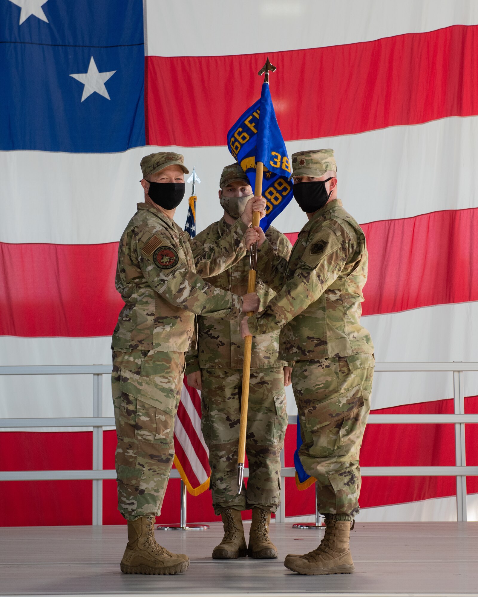 Col. DiVittorio gives the official squadron guidon to Maj. Reis Griffin