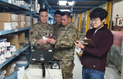 Members of the U.S. Army Medical Materiel Center-Korea's Distribution Center team verify Class VIII medical materiel stock in the warehouse as part of the center's "Brand to Generic" prescription medication initiative. Pictured, from left, are Capt. Benjamin Lee, Pfc. Jin Su Oh, Master Sgt. Rizmel Paguio and Kim Sung-hwan. (U.S. Army photo by Paek Hye-chin)