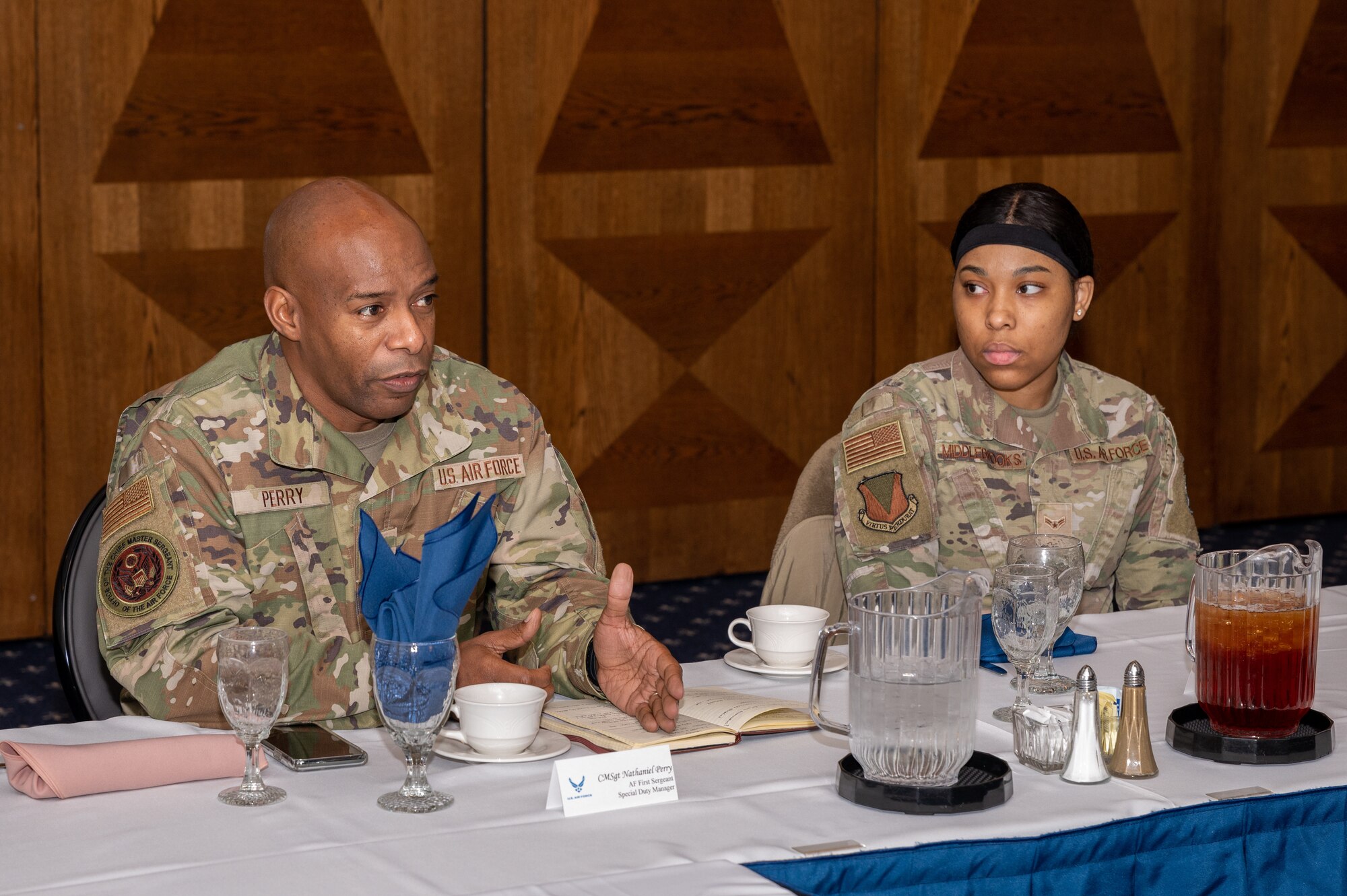 Two military members sitting at a table.