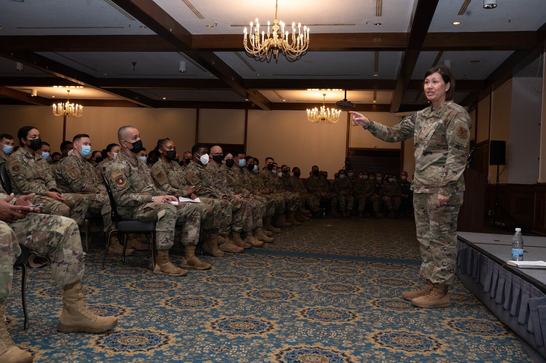 A military member speaking in front of a crowd.