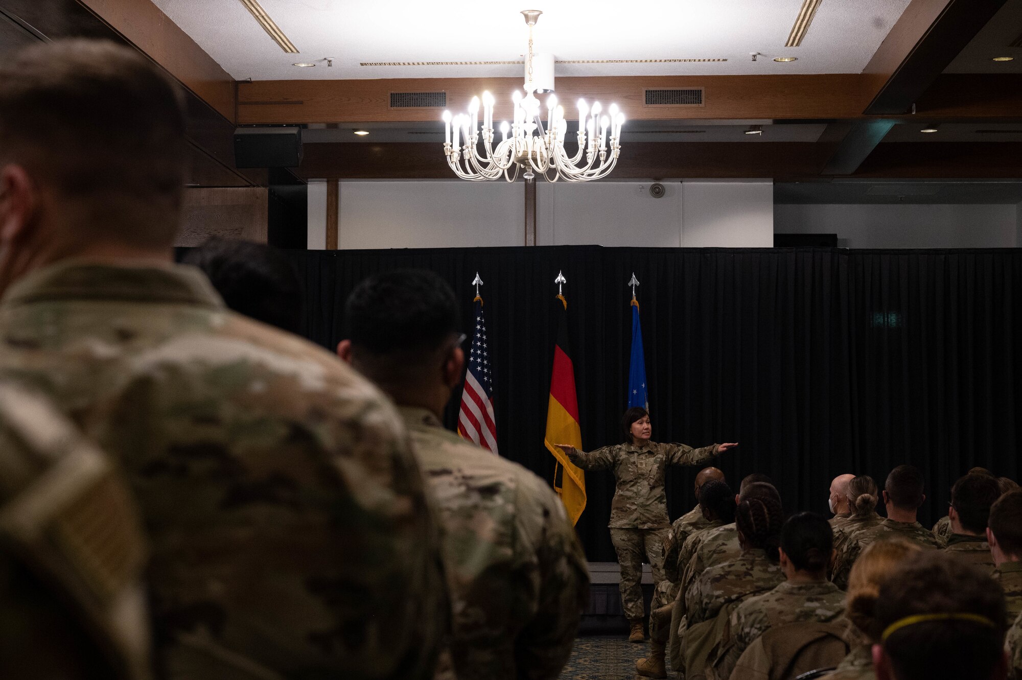 A military member speaking in front of a crowd.
