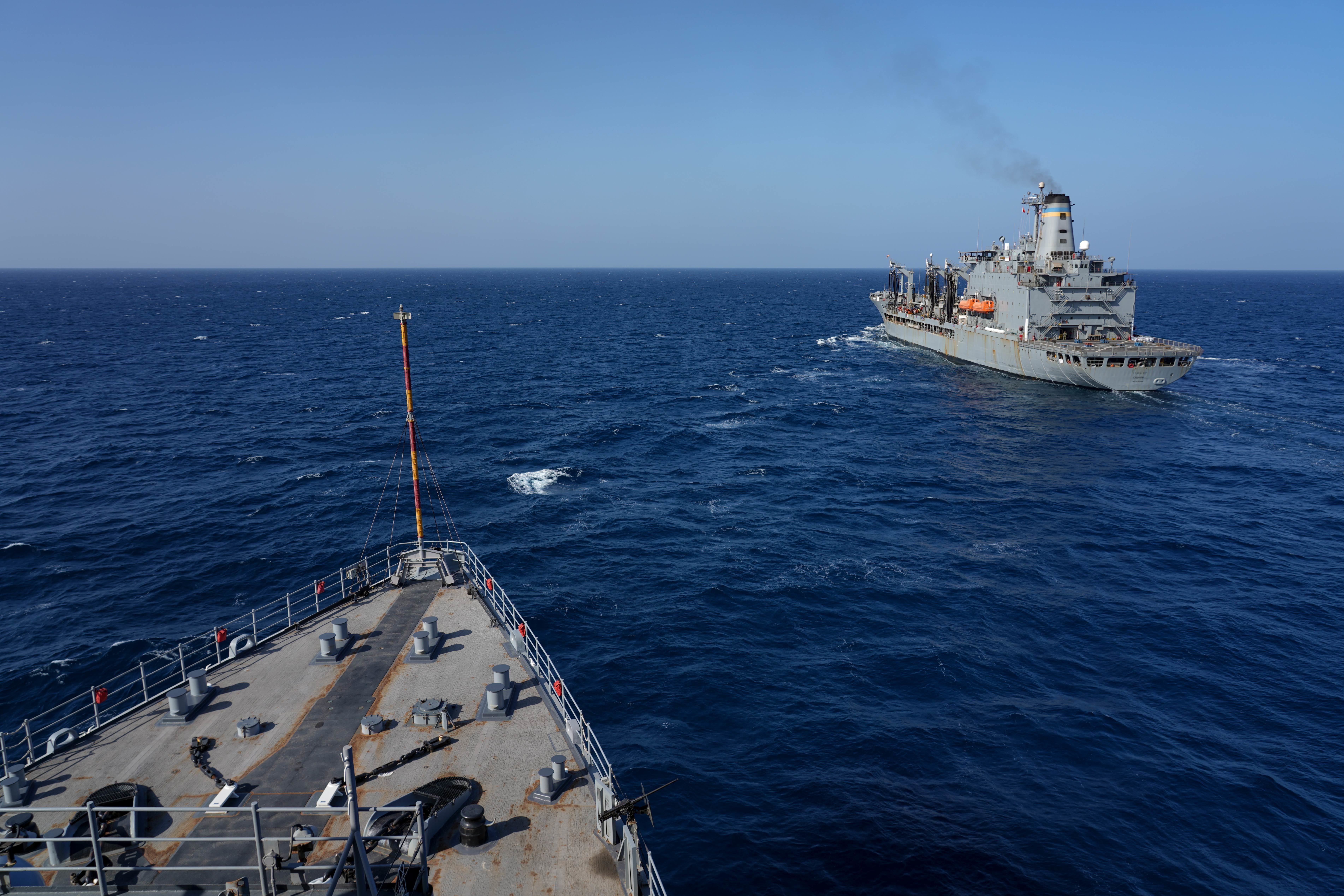 USNS Kanawha (T-AO 196) prepares to sail alongside the amphibious dock landing ship USS Pearl Harbor (LSD 52) during an underway replenishment operation in the Gulf of Aden.