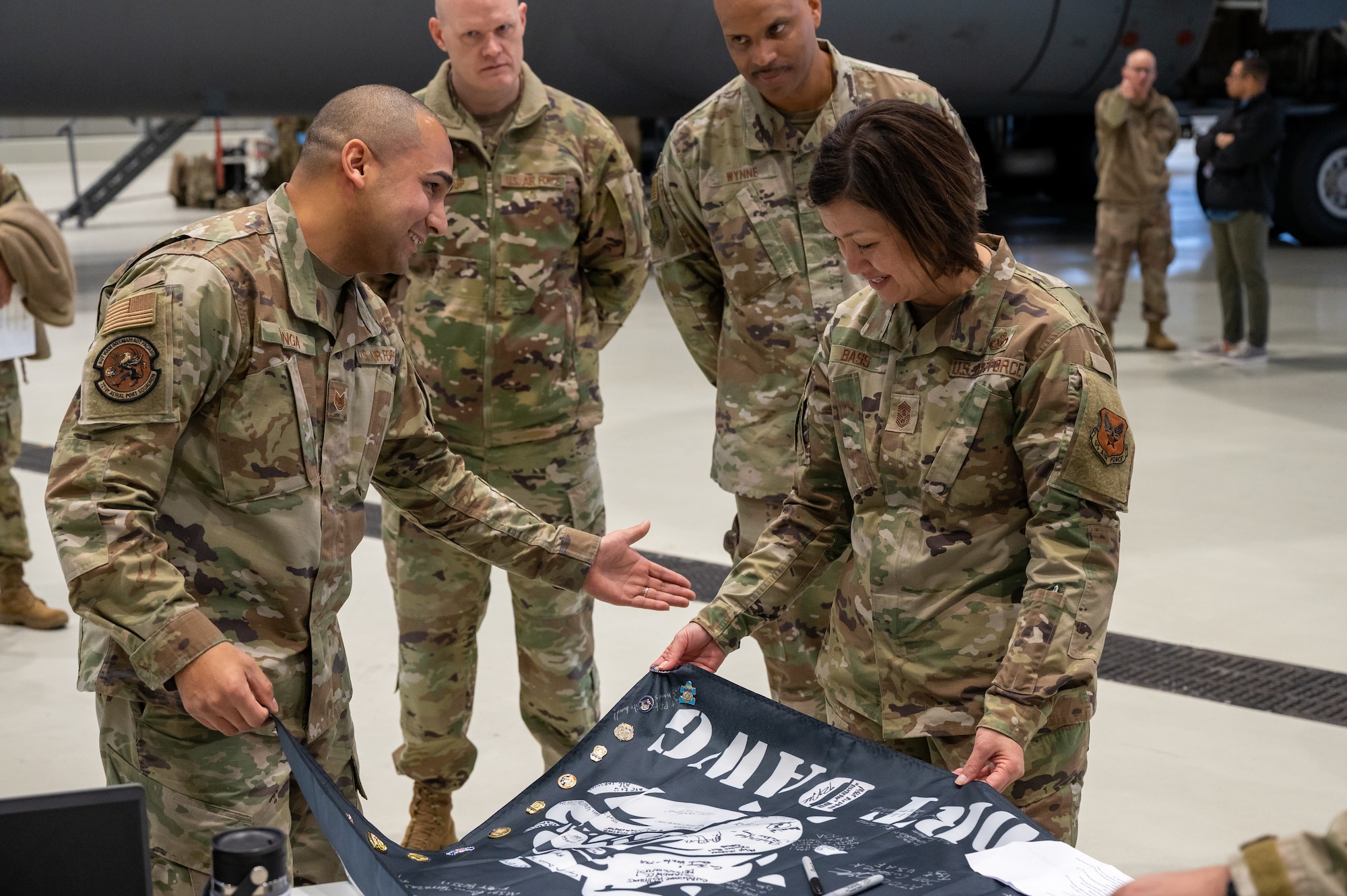 A group of military members standing around a flag.