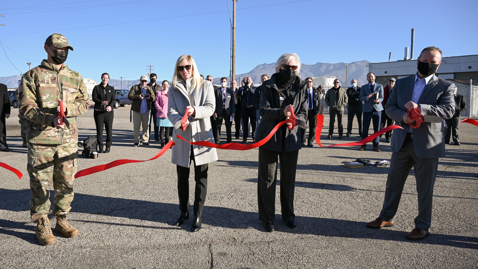Leaders cut a ribbon to celebrate the first deployed and functional 5G network on a U.S. military installation at Hill Air Force Base