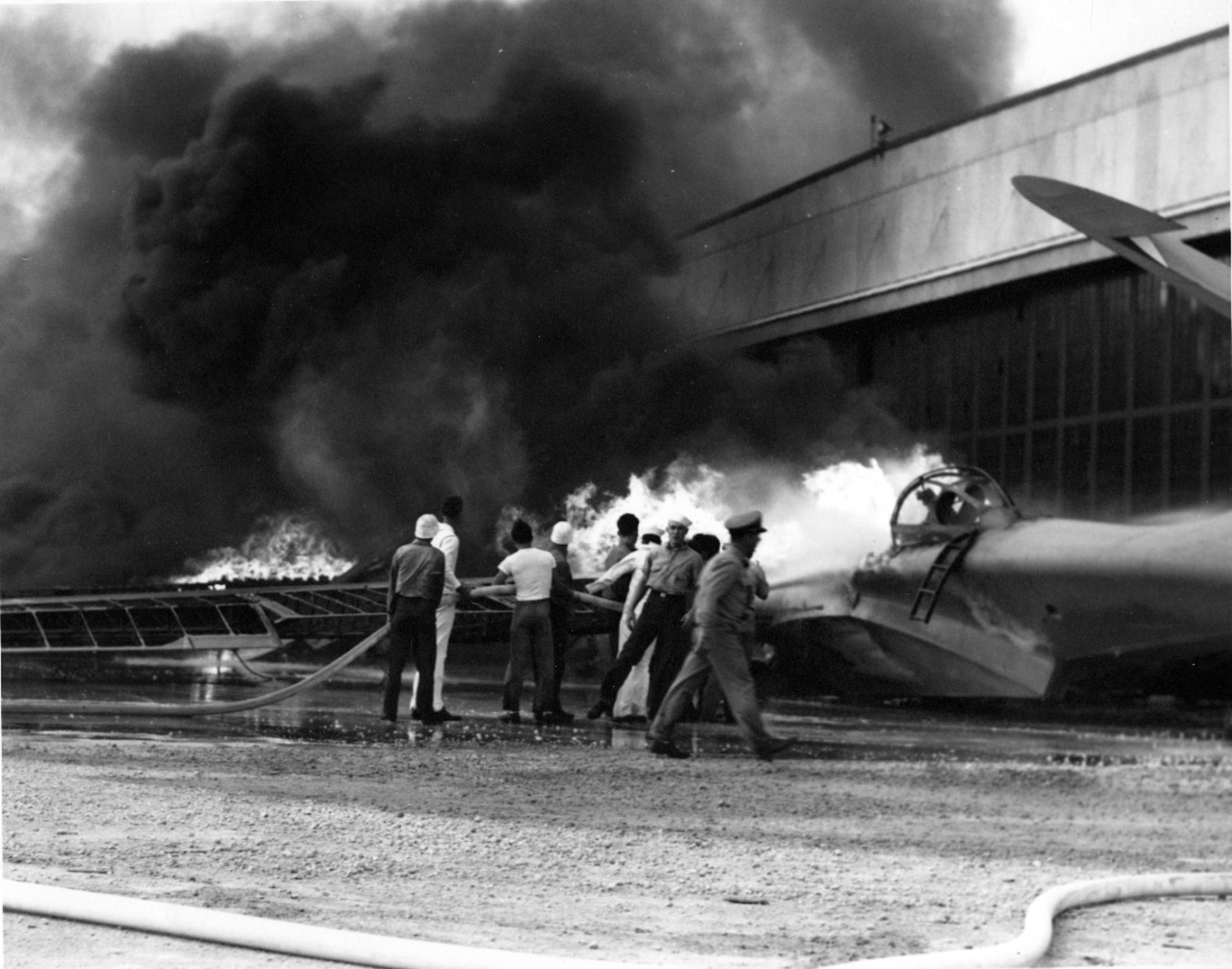 Men fight a fire on an airplane.