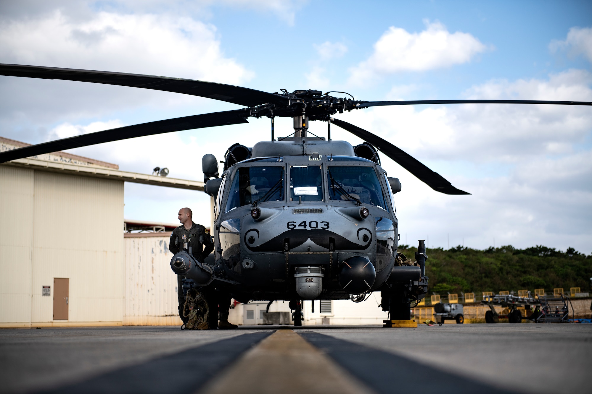 U.S Air Force 1st Lt. Trent Badger, 33rd Rescue Squadron co-pilot, checks an HH-60G Pave Hawk prior to a training flight at Kadena Air Base, Japan, Dec. 1, 2021. The 33rd RQS conducts extensive training in various rescue scenarios to ensure they are ready to effectively respond to real-world contingencies. (U.S. Air Force photo by Senior Airman Jessi Monte)